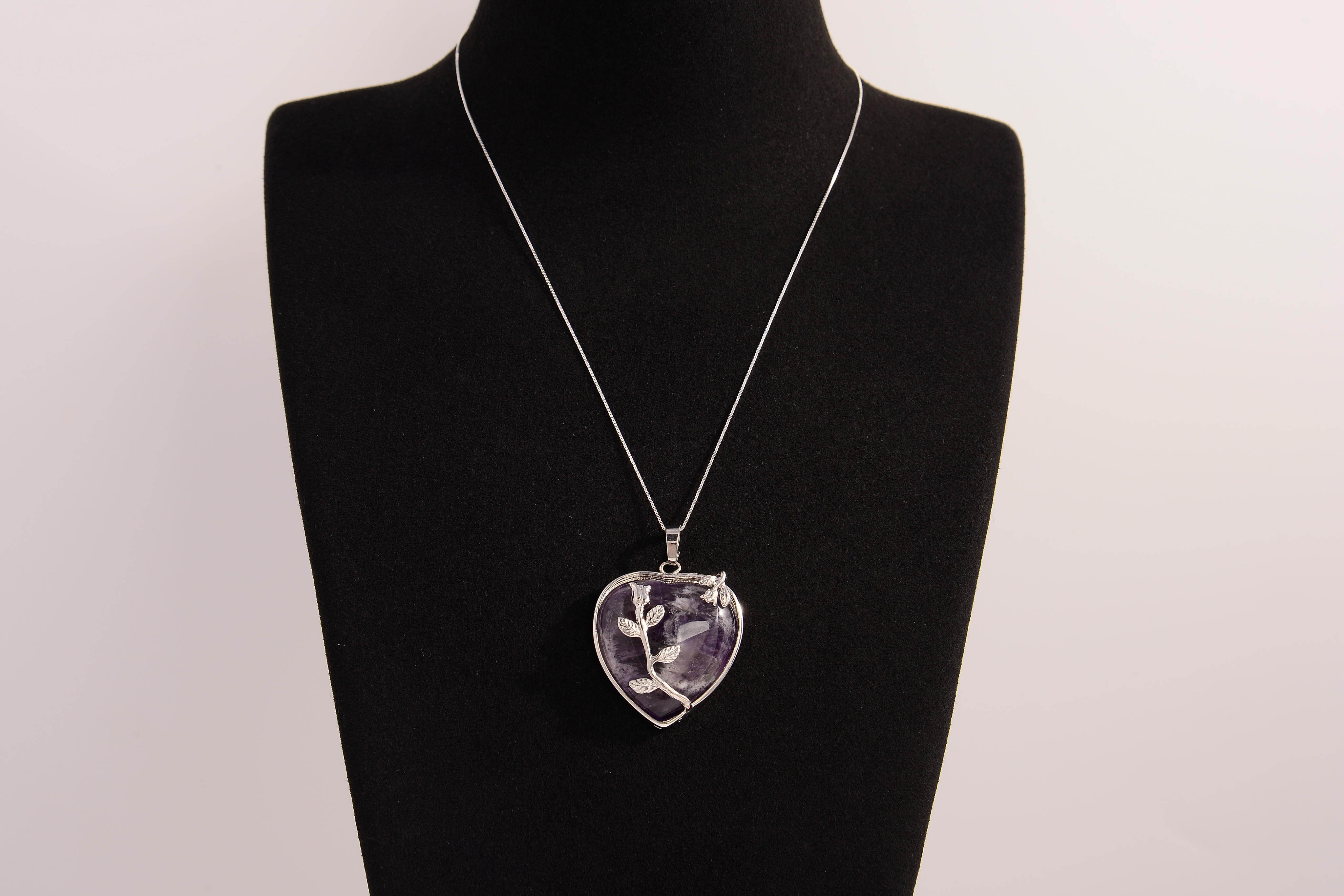 Raw Earth Crystals amethyst heart pendant with an elegant rose design, featuring a deep purple amethyst stone and a silver-tone vine with leaves, promoting spiritual growth, intuition, and inner peace.