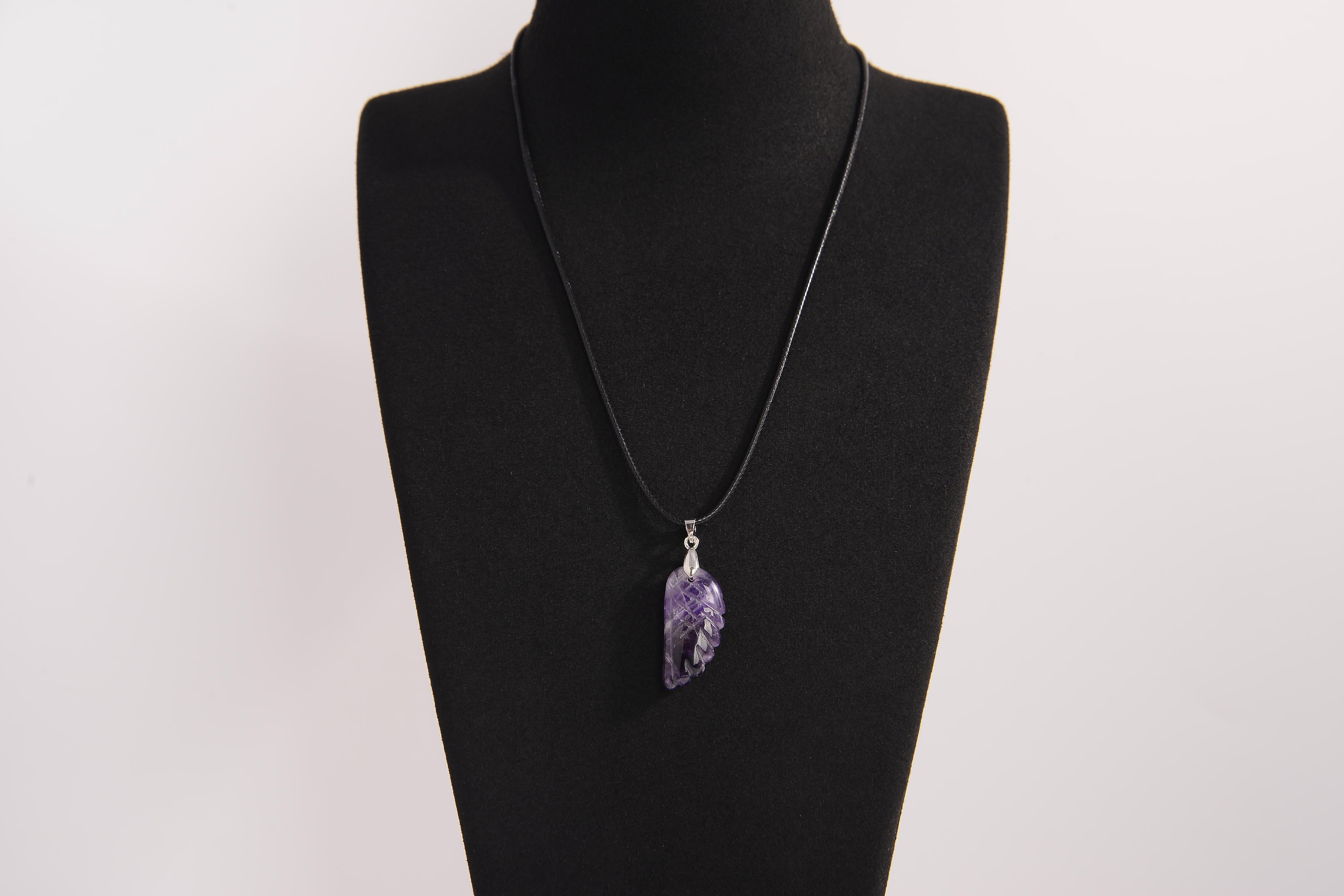 Raw Earth Crystals amethyst pendant featuring an etched design, crafted from natural stone to enhance spiritual awareness, calm the mind, and support emotional balance.