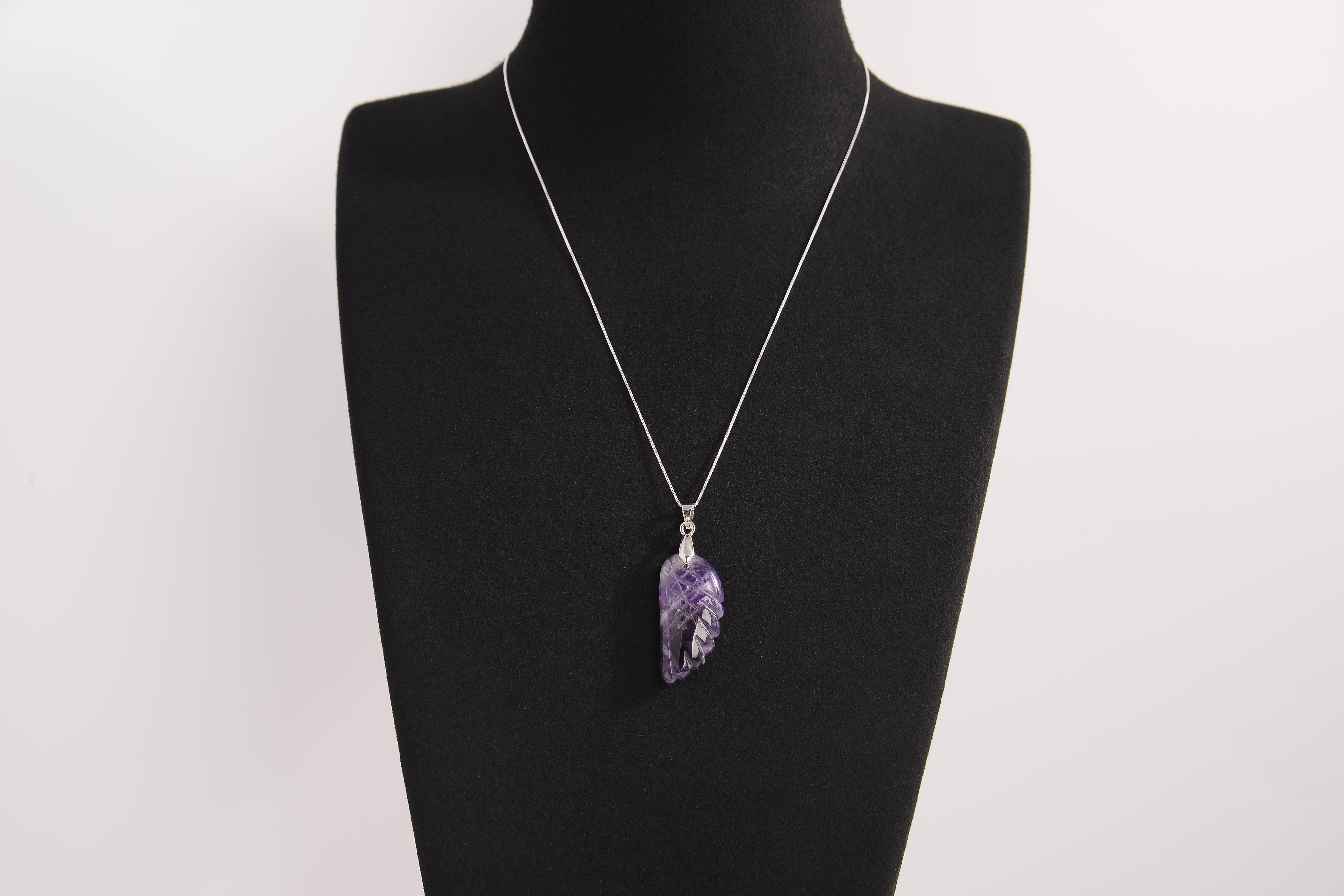 Raw Earth Crystals amethyst pendant featuring an etched design, crafted from natural stone to enhance spiritual awareness, calm the mind, and support emotional balance.