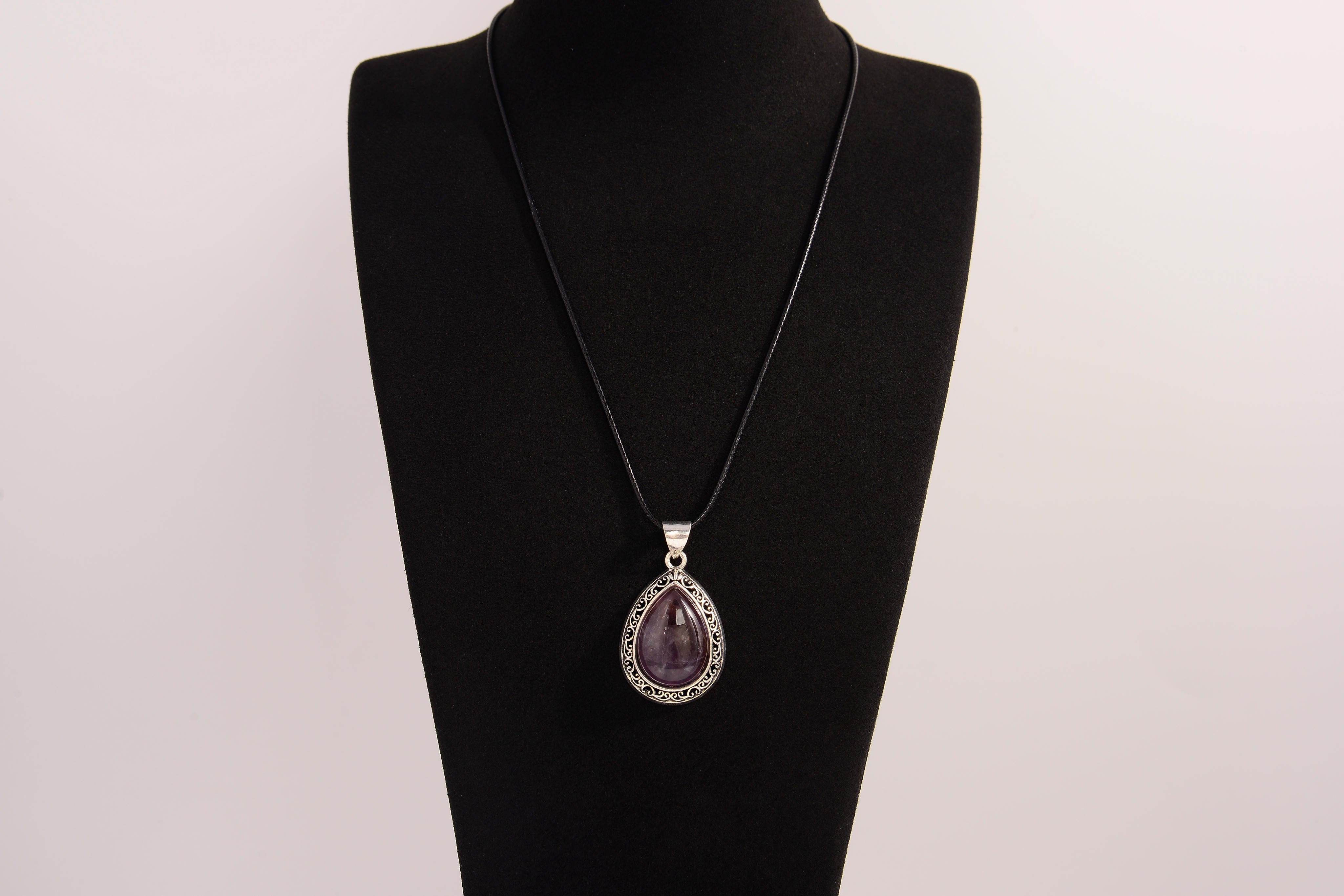 Raw Earth Crystals amethyst pendant with a teardrop-shaped design, featuring natural amethyst and an ornate silver-tone setting, promoting spiritual growth, calmness, and intuition.