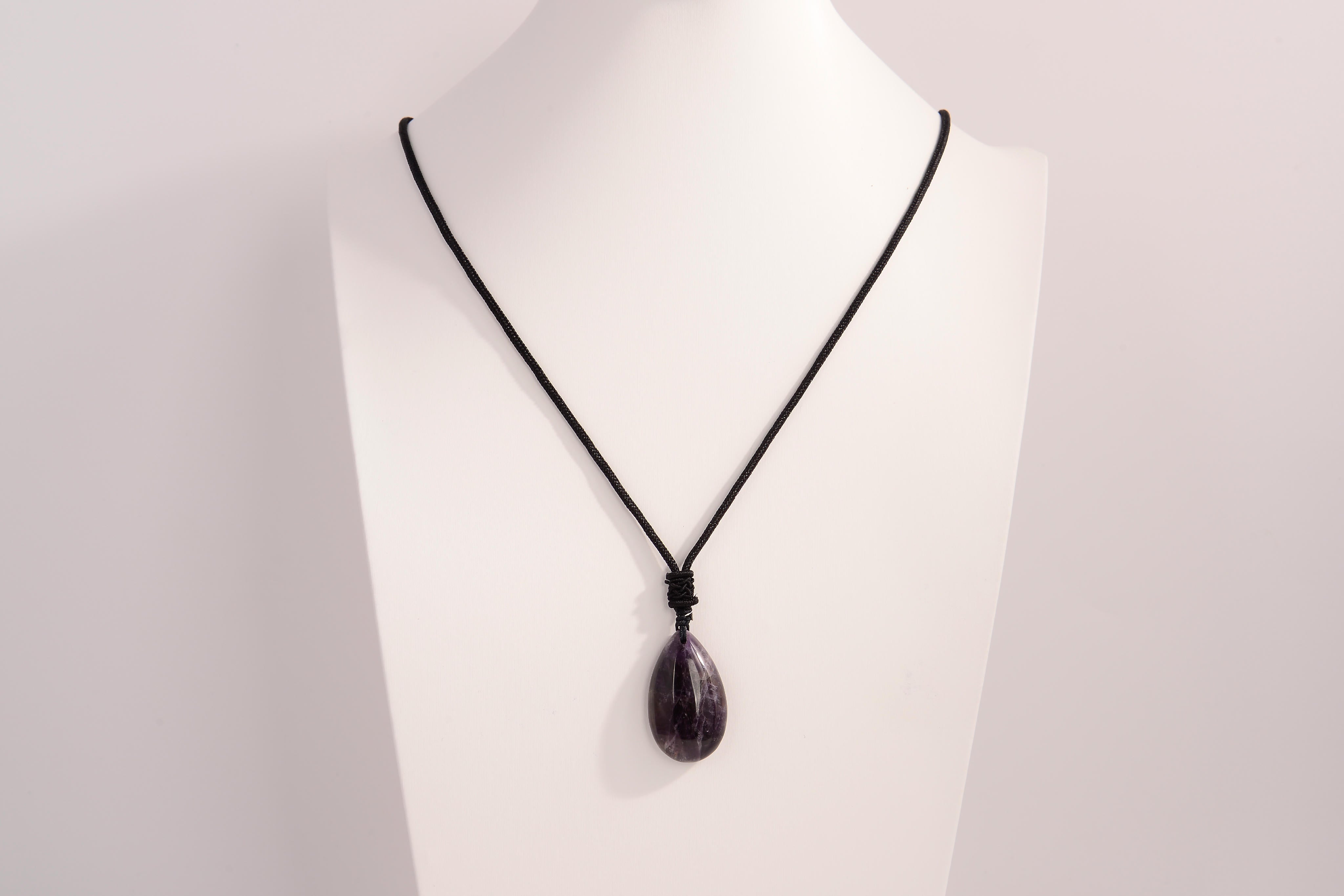Raw Earth Crystals amethyst teardrop pendant on black cord, made from natural amethyst stone, supporting spiritual growth, calmness, and intuitive clarity.