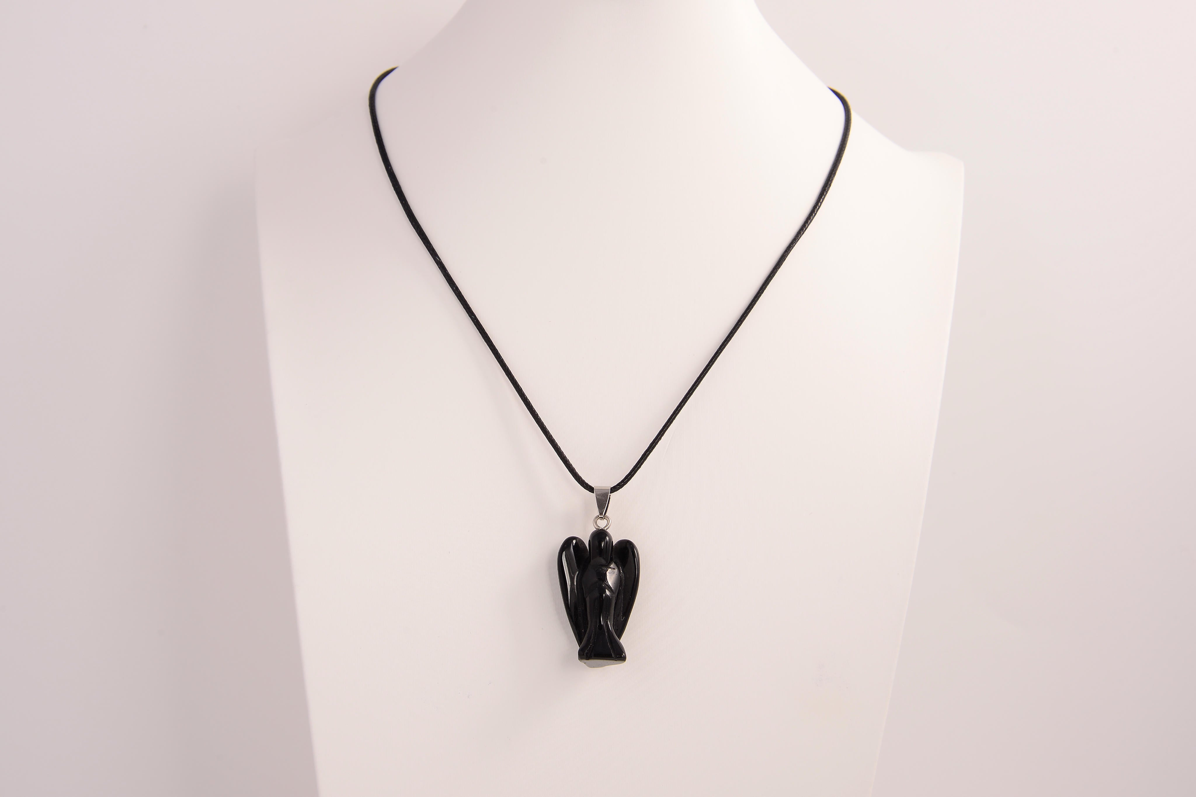 Raw Earth Crystals angel pendant crafted from carved obsidian, featuring a sleek, polished design to promote protection, grounding, and spiritual clarity.