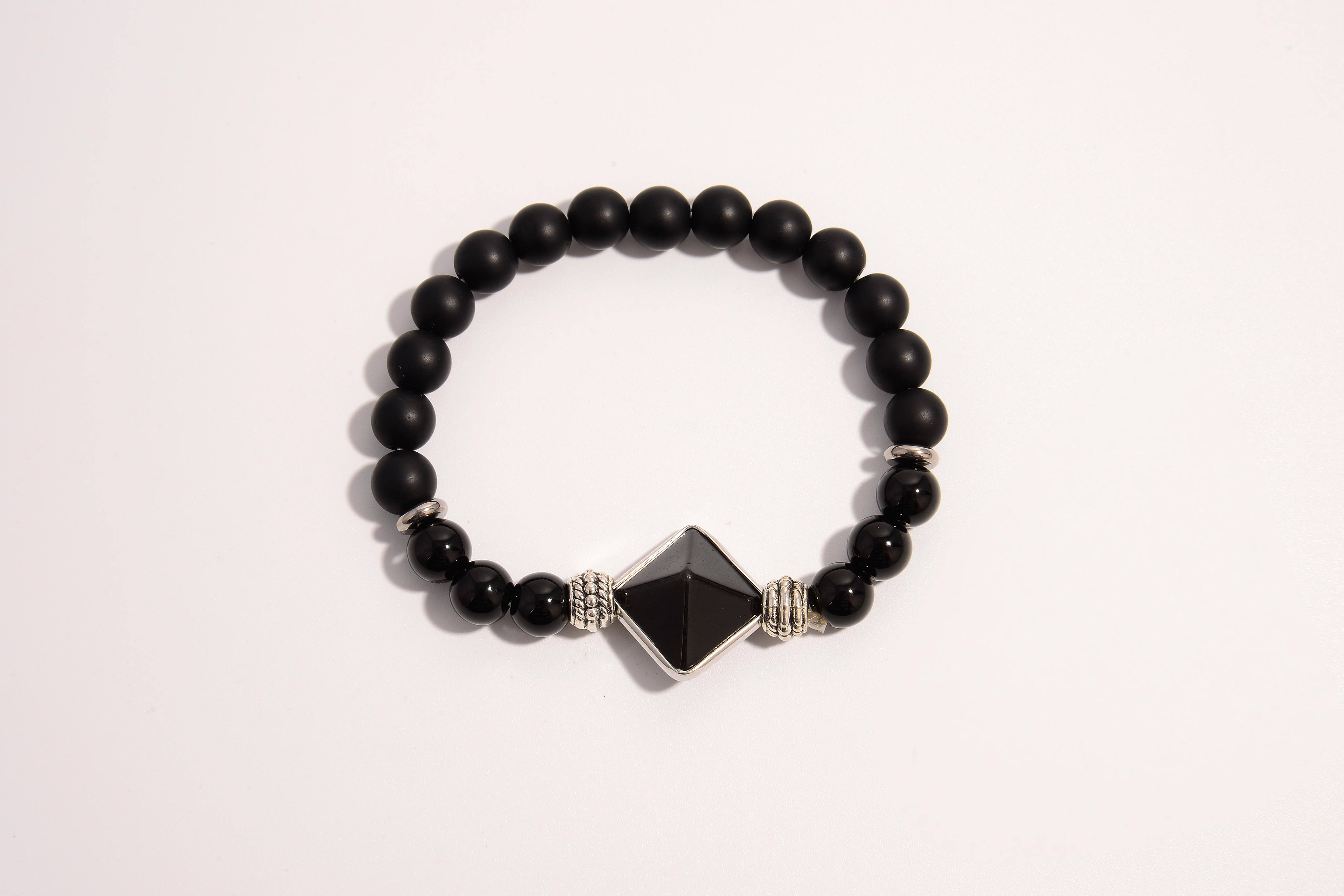 Raw Earth Crystals black onyx and black tourmaline bracelet with silver accent, crafted from natural crystals, promotes protection, grounding, and spiritual clarity.