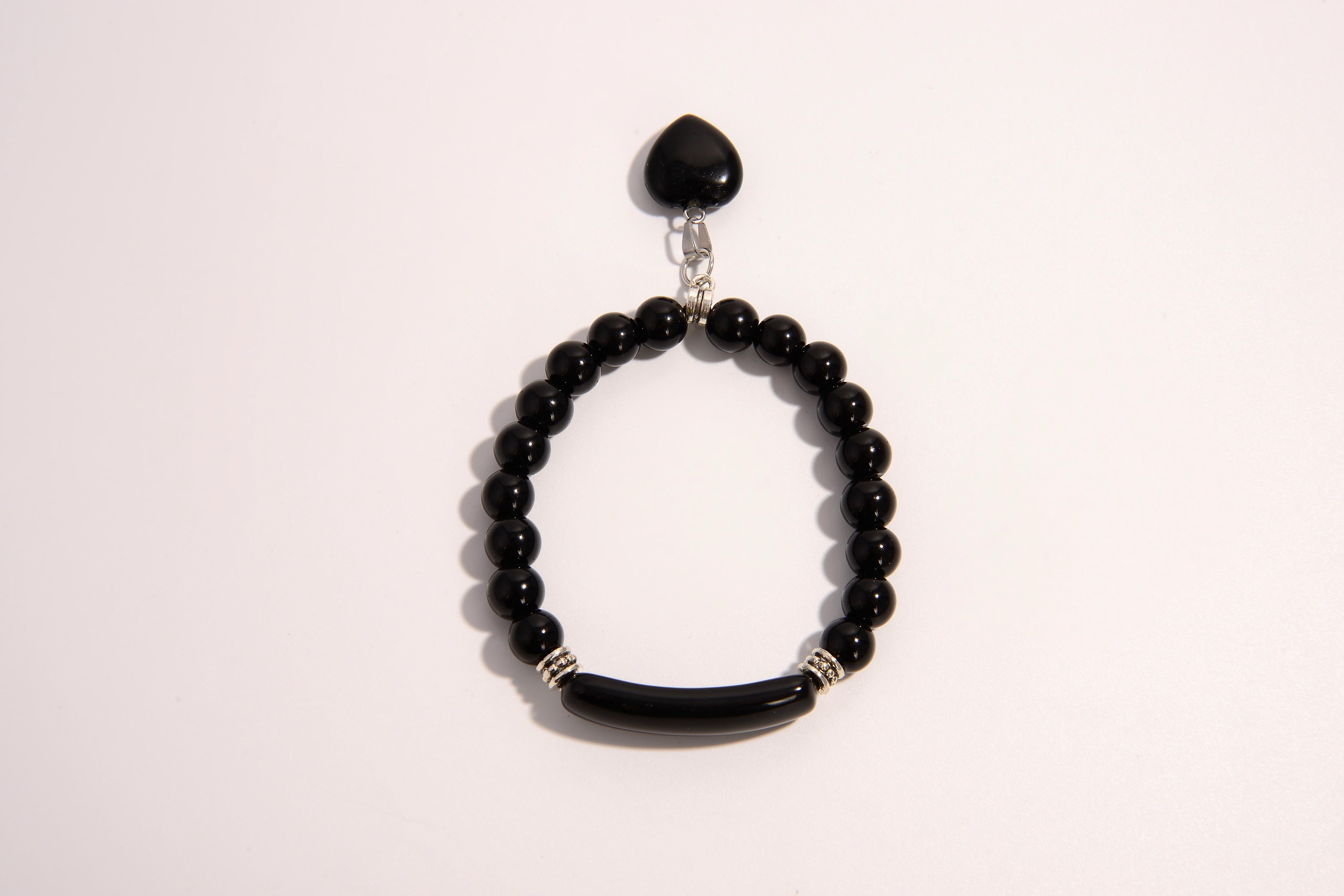 Raw Earth Crystals black onyx bracelet with raw stone accent, made from natural crystal, supports protection, grounding, and emotional stability.
