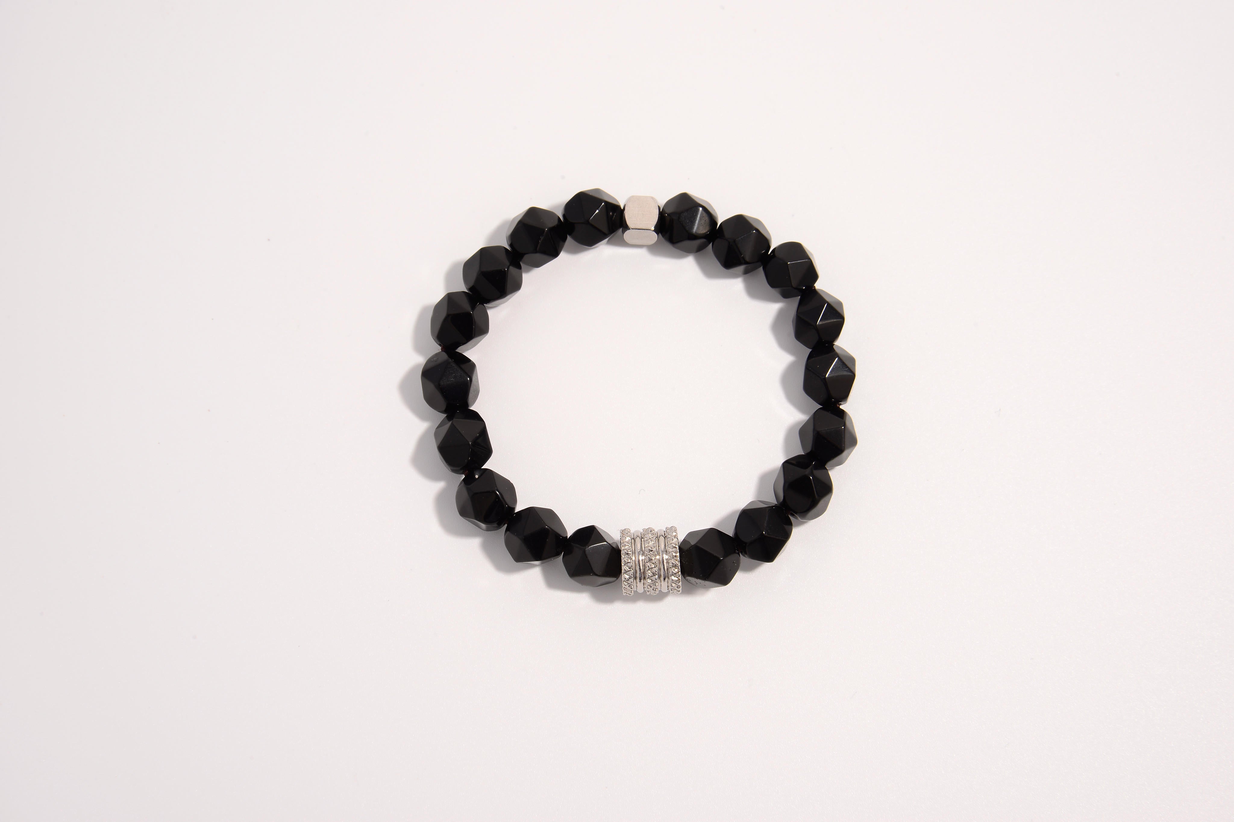 Raw Earth Crystals black onyx faceted bracelet with silver accent, crafted from natural crystal, promotes strength, protection, and emotional balance.