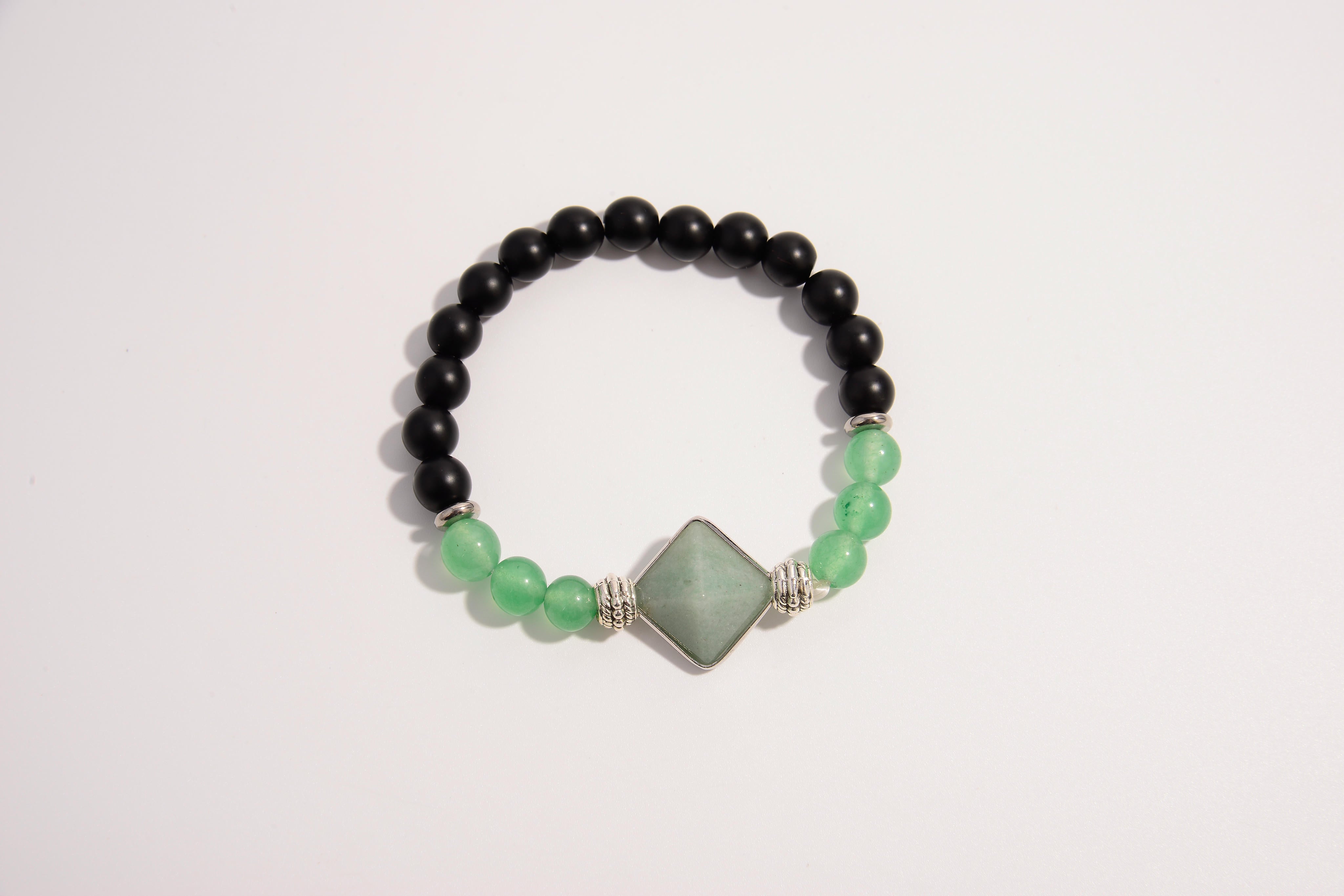 Raw Earth Crystals black onyx and green aventurine bracelet with silver accent, crafted from natural crystals, promotes balance, prosperity, and emotional harmony.