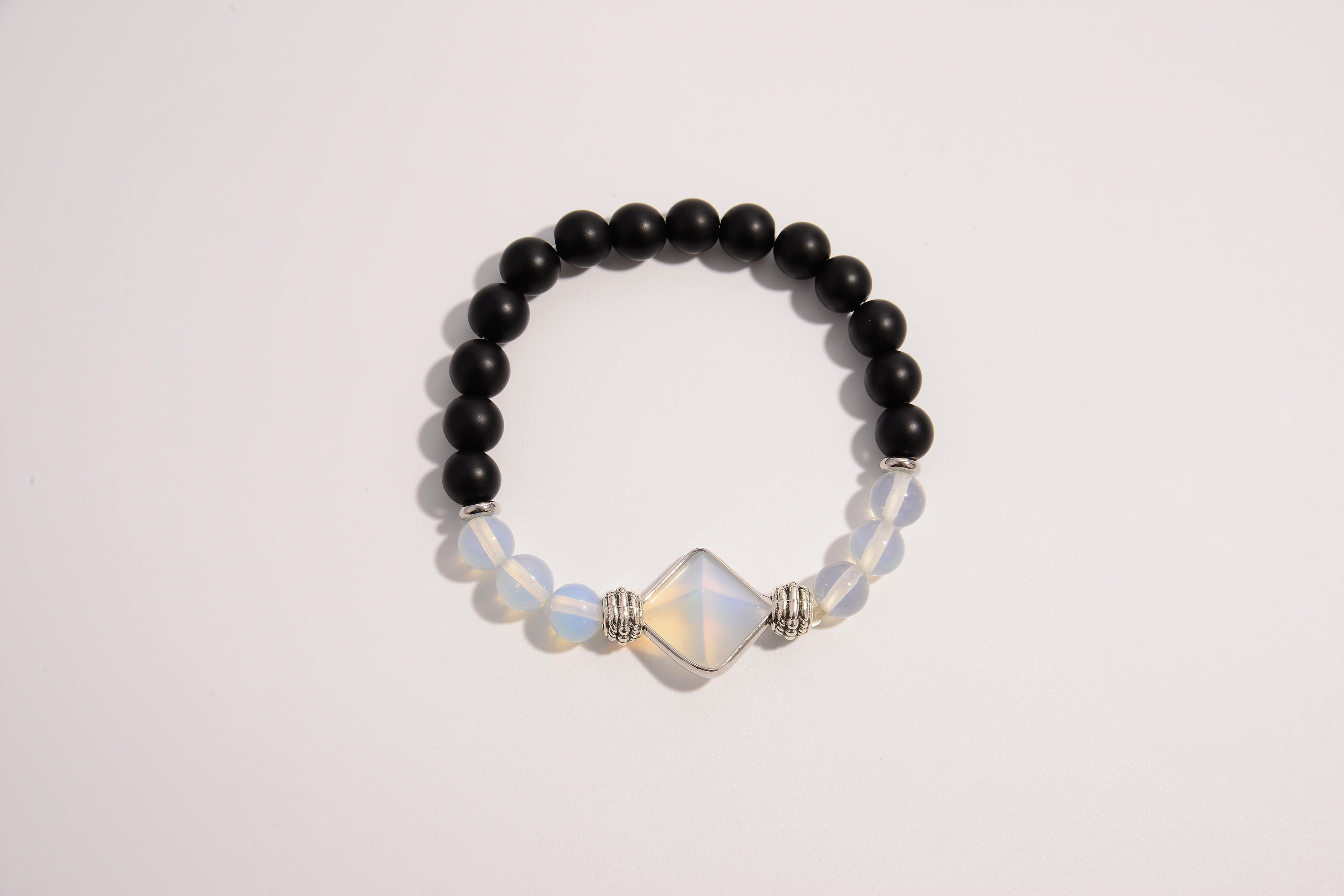Raw Earth Crystals black onyx and opal bracelet with silver accent, crafted from natural crystals, promotes grounding, emotional balance, and inner peace.