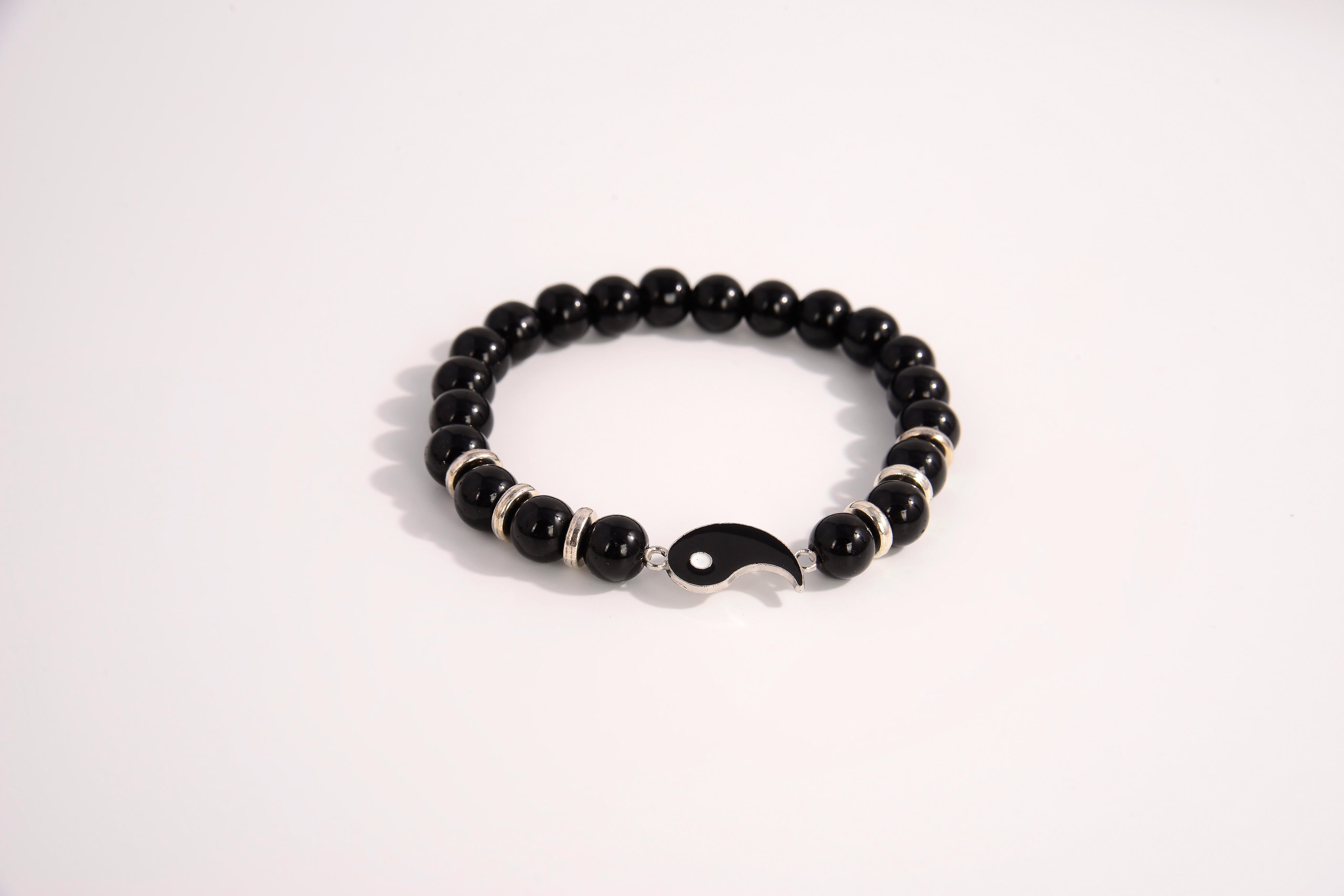 Raw Earth Crystals black tourmaline bracelet with yin yang design, made from natural crystal, supports balance, protection, and spiritual harmony.