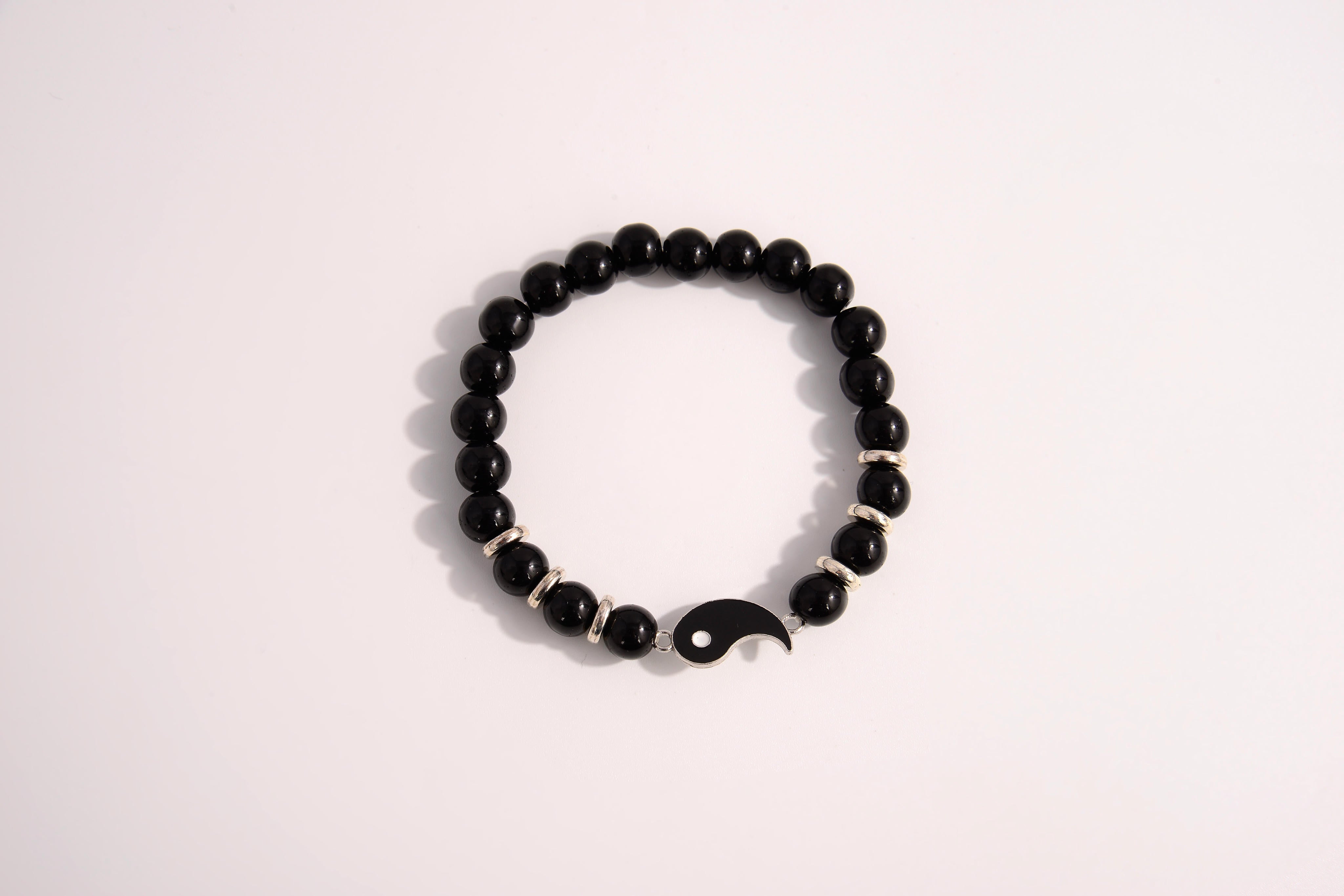 Raw Earth Crystals black tourmaline bracelet with yin yang design, crafted from natural crystal, promotes balance, protection, and inner clarity.