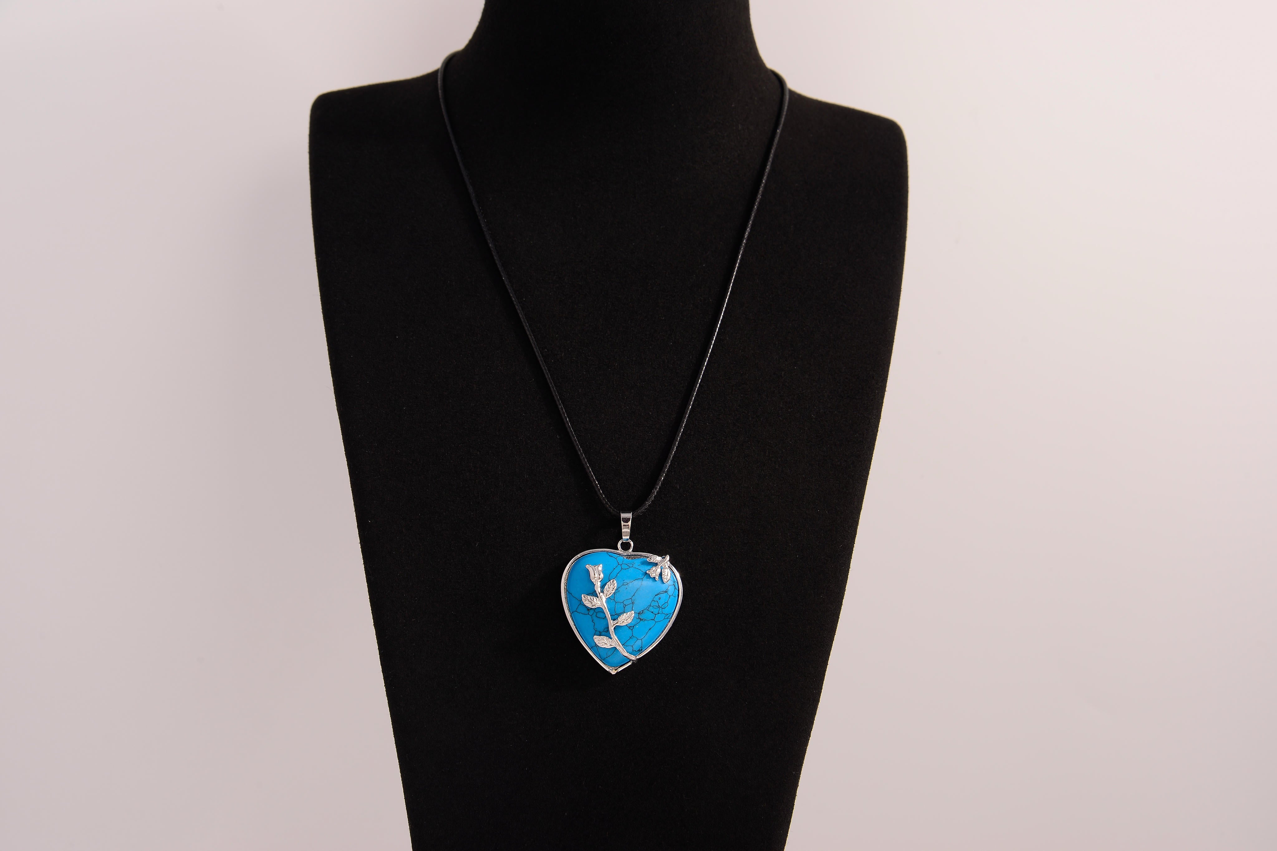 Raw Earth Crystals blue howlite heart pendant with an elegant rose design, featuring a vibrant blue howlite stone and a silver-tone vine with leaves, promoting calmness, emotional stability, and focus.
