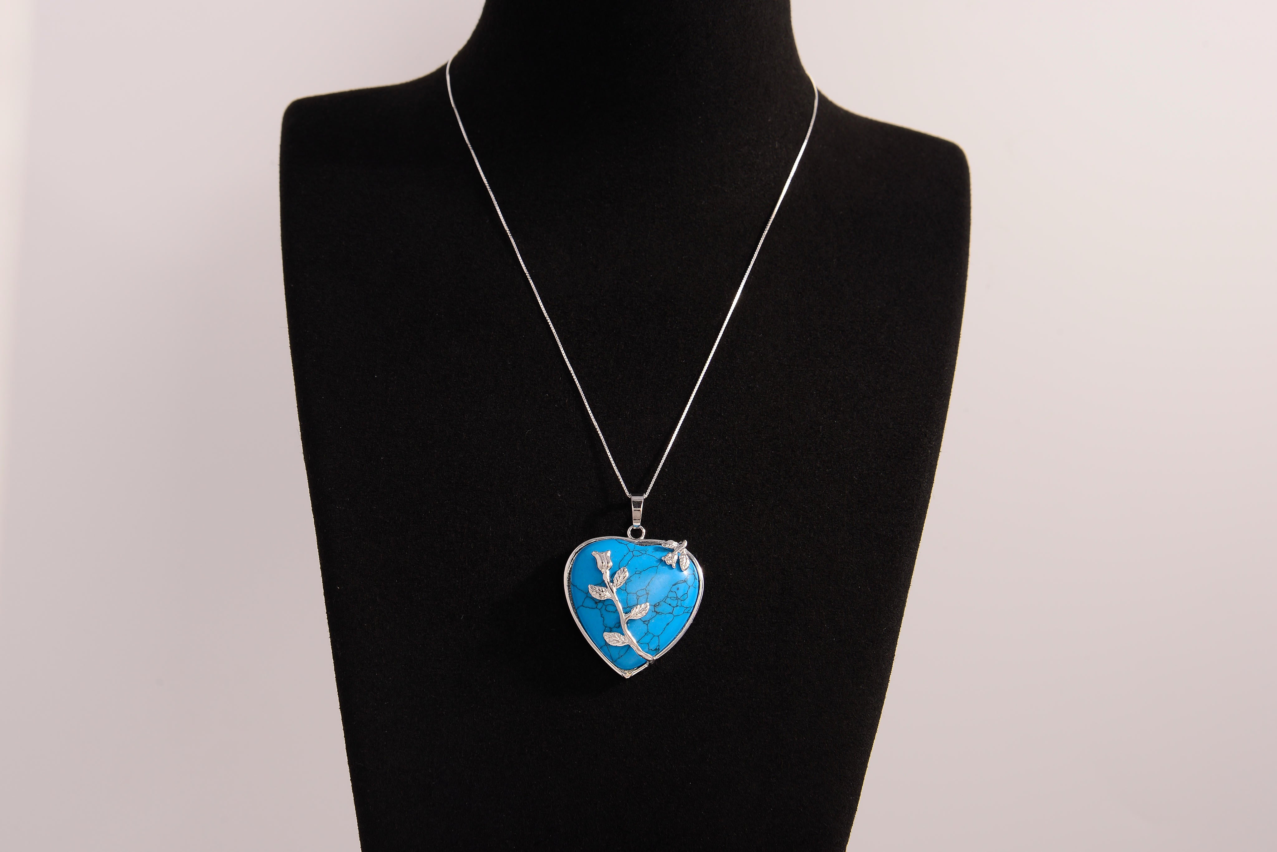 Raw Earth Crystals blue howlite heart pendant with an elegant rose design, featuring a vibrant blue howlite stone and a silver-tone vine with leaves, promoting calmness, emotional stability, and focus.