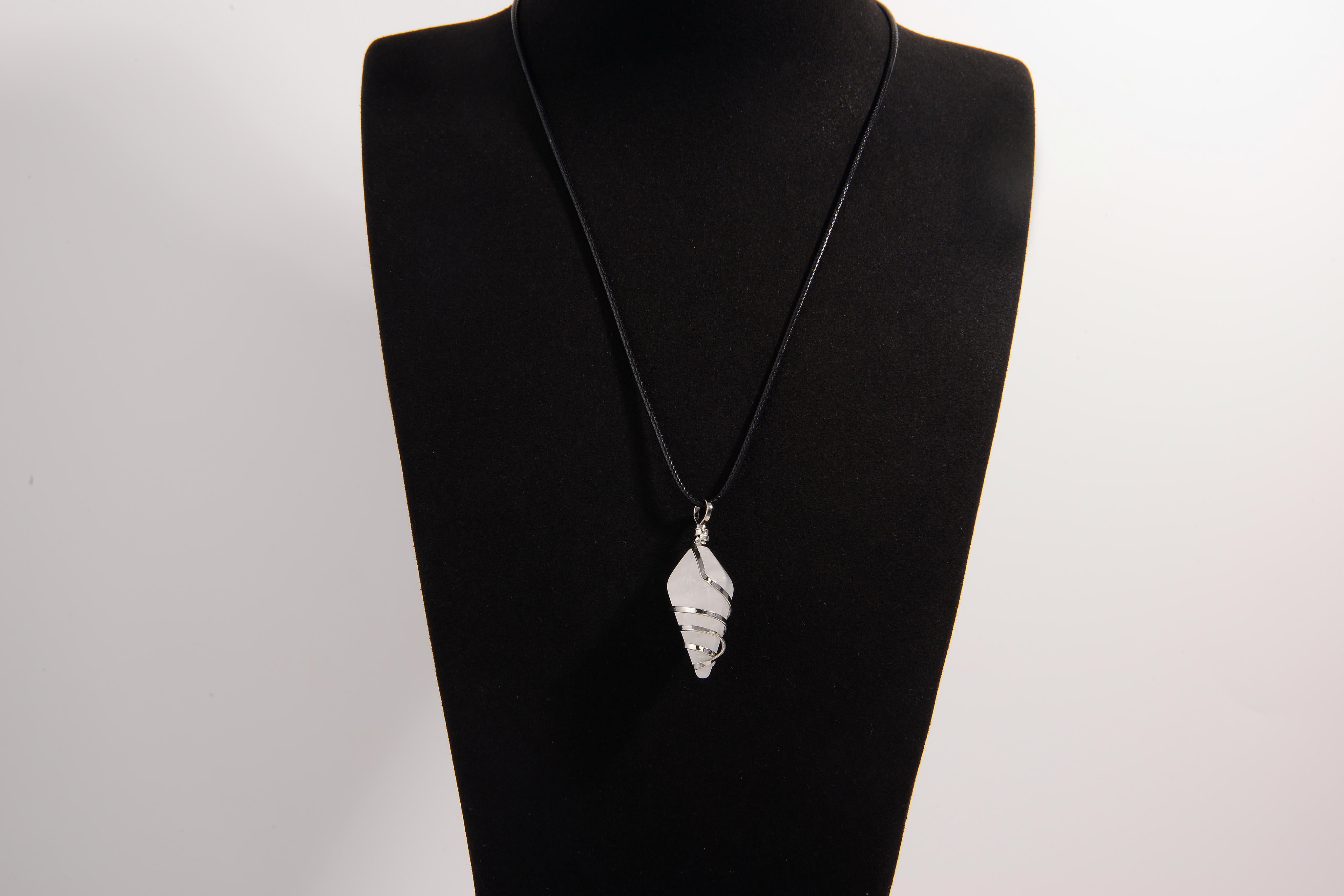 Raw Earth Crystals clear quartz pendant with a spiral wire wrap design, crafted from natural stone to enhance clarity, focus, and spiritual energy.
