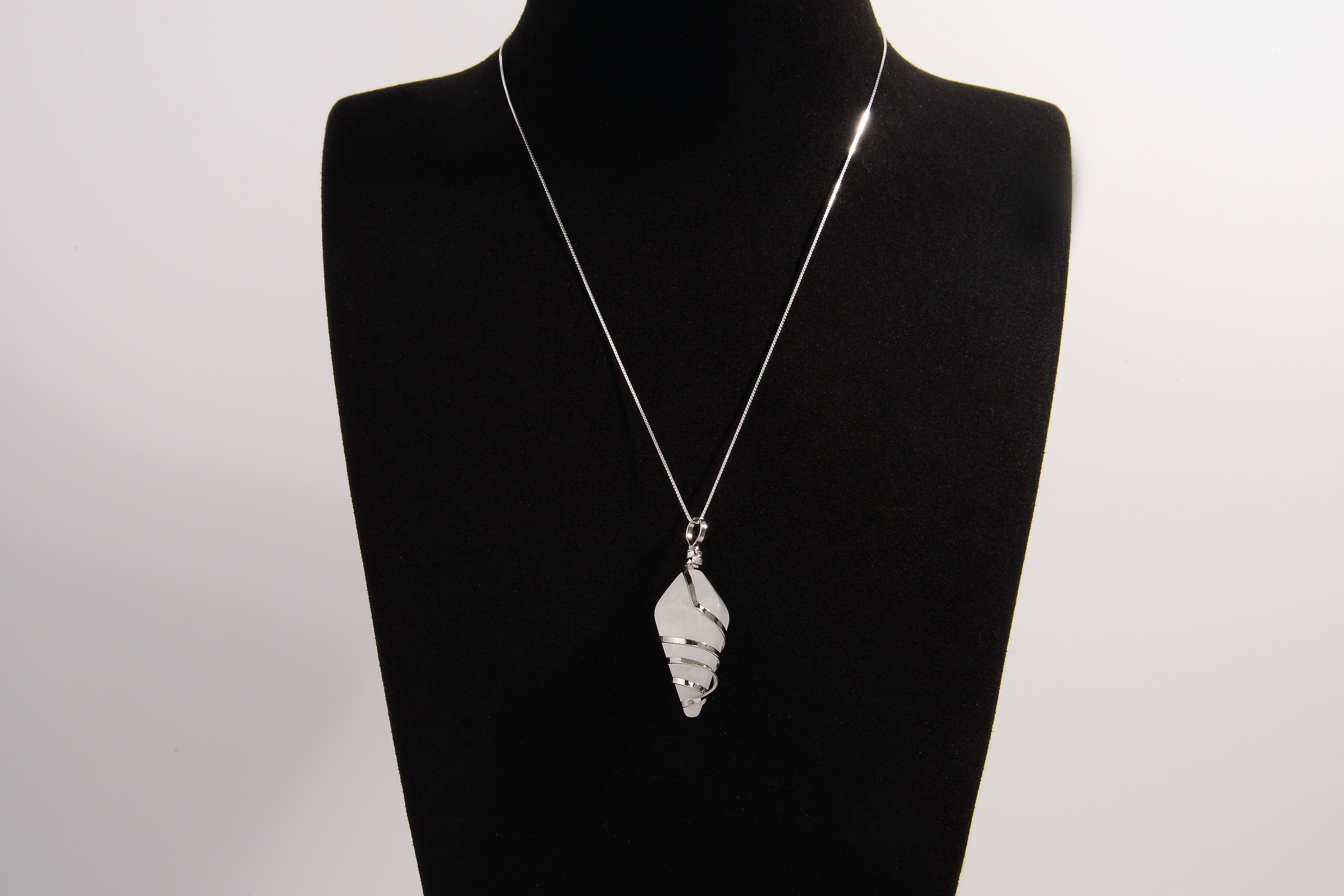 Raw Earth Crystals clear quartz pendant with a spiral wire wrap design, crafted from natural stone to enhance clarity, focus, and spiritual energy.
