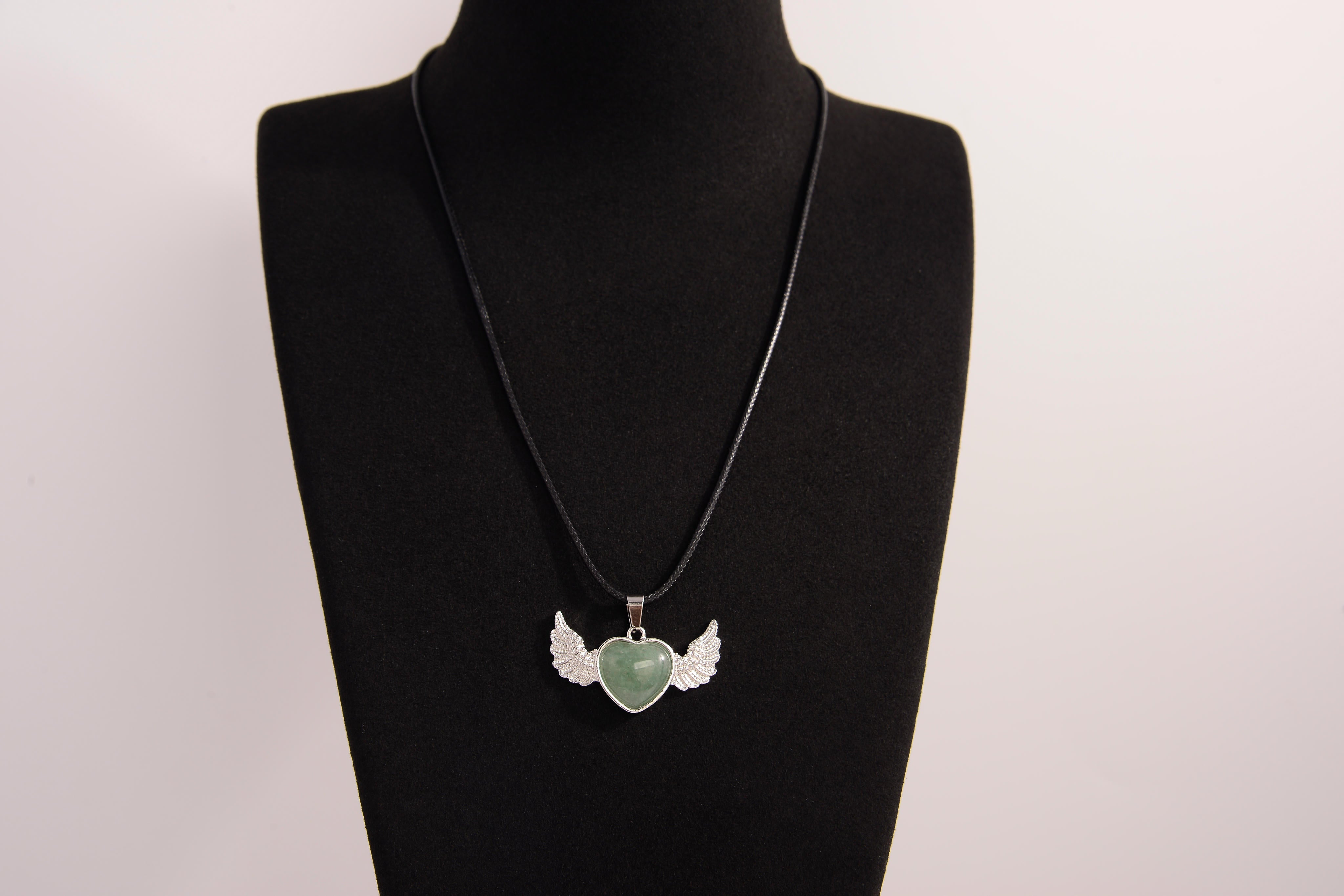 Raw Earth Crystals green aventurine heart with wings necklace, featuring a vibrant green heart-shaped stone adorned with delicate angelic wings, designed to promote abundance, emotional balance, and spiritual growth.