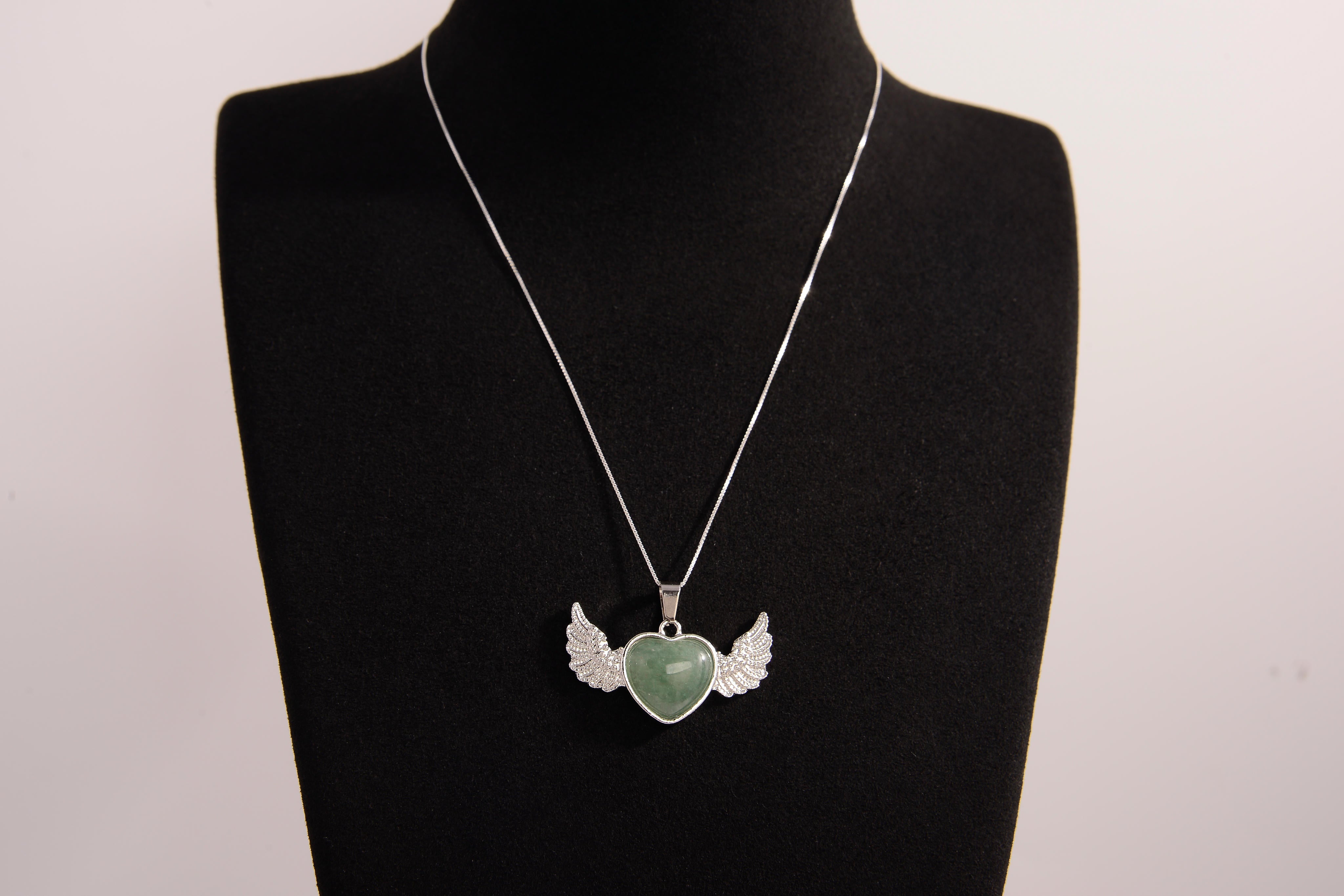 Raw Earth Crystals green aventurine heart with wings necklace, featuring a vibrant green heart-shaped stone adorned with delicate angelic wings, designed to promote abundance, emotional balance, and spiritual growth.