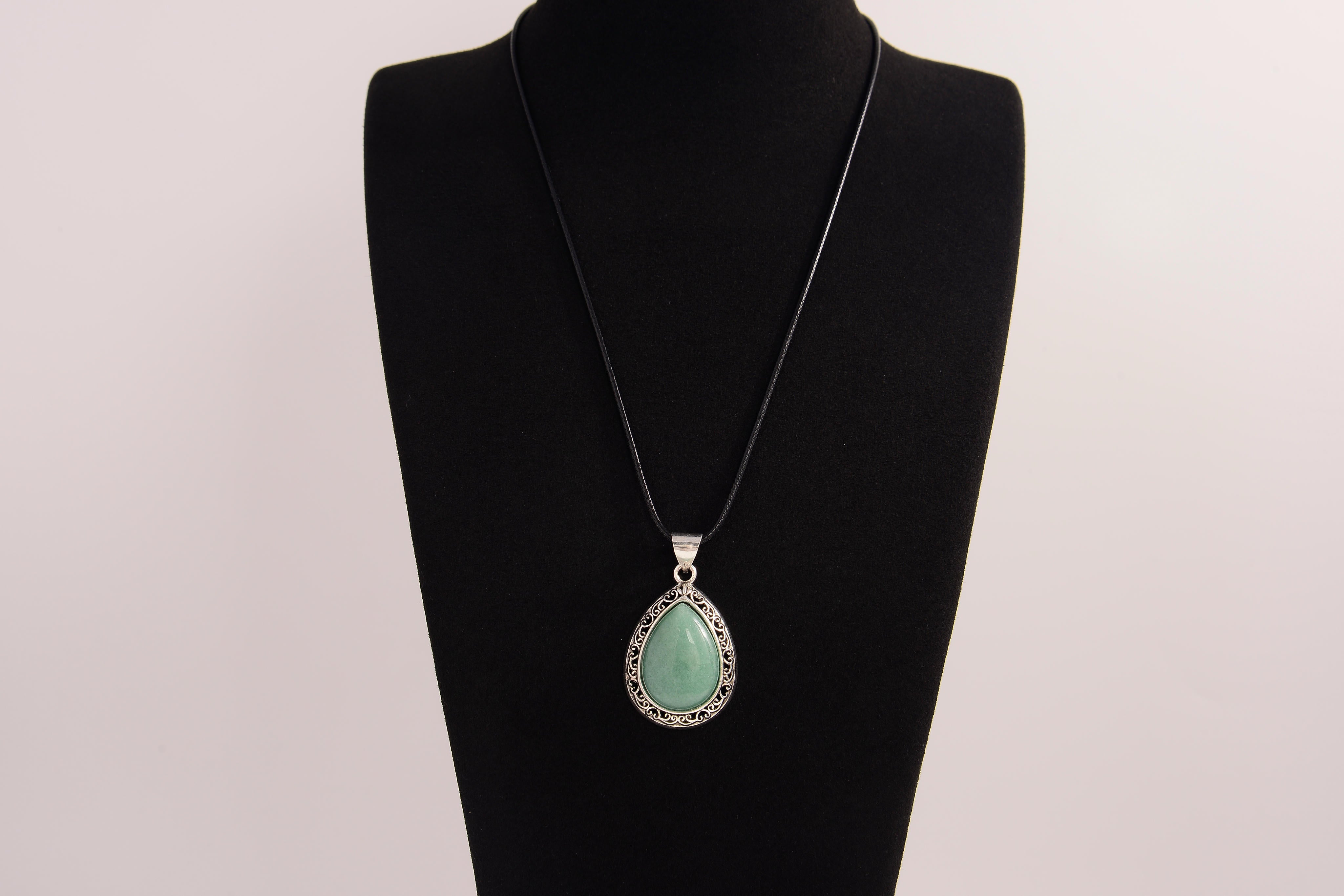 Raw Earth Crystals green aventurine pendant with a teardrop-shaped design, featuring natural green aventurine and an ornate silver-tone setting, promoting prosperity, luck, and emotional balance.