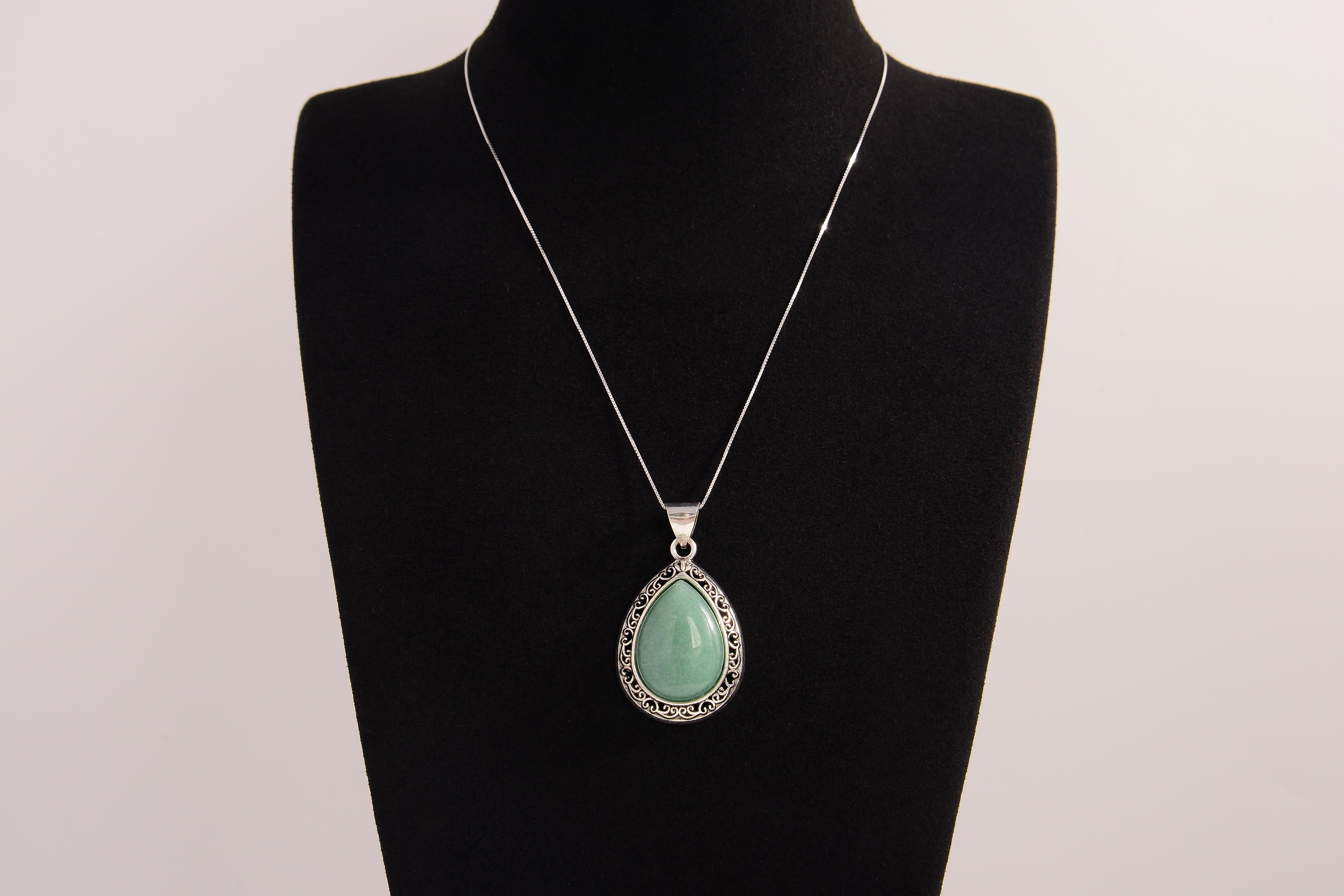 Raw Earth Crystals green aventurine pendant with a teardrop-shaped design, featuring natural green aventurine and an ornate silver-tone setting, promoting prosperity, luck, and emotional balance.