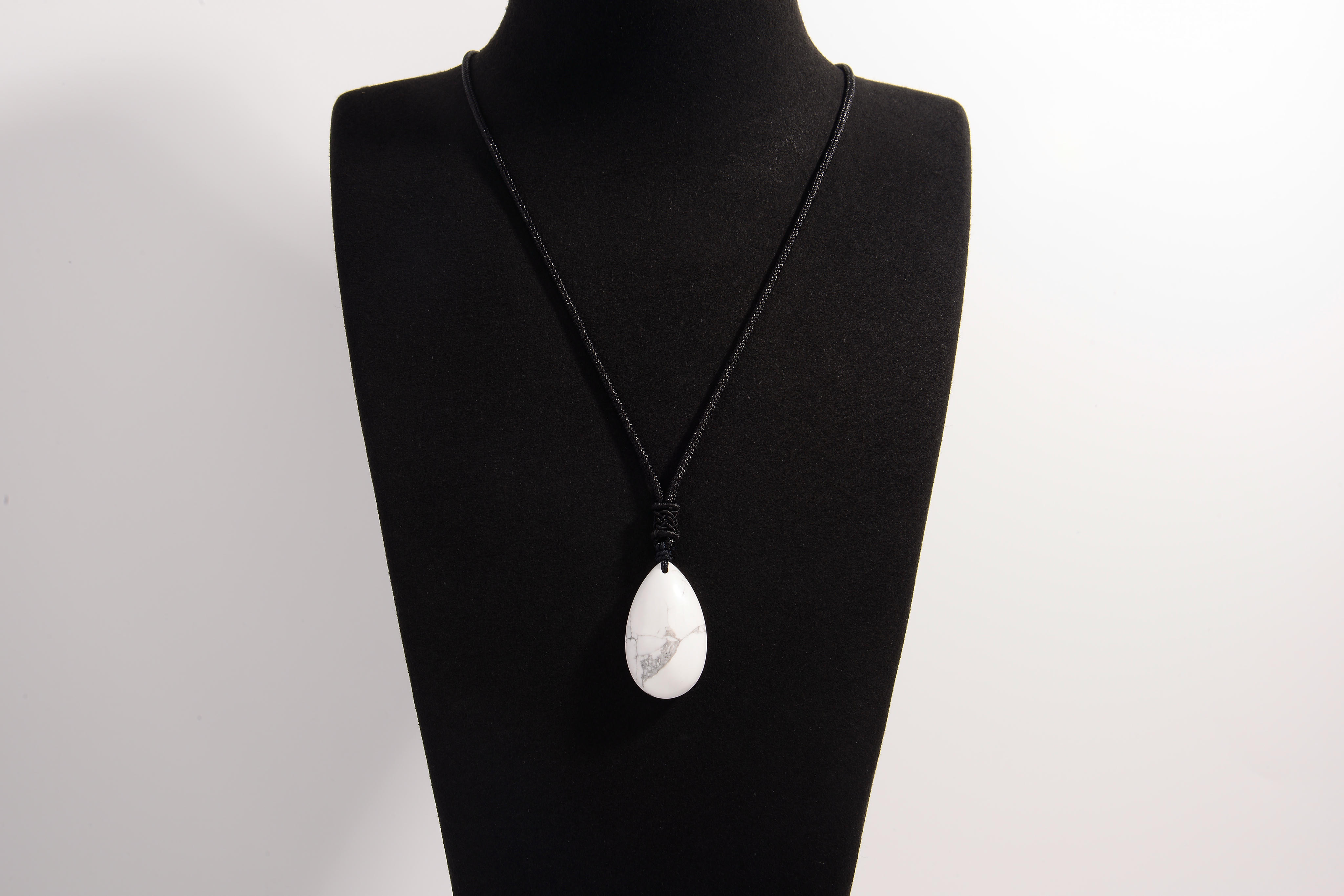 Raw Earth Crystals howlite teardrop pendant on black cord, crafted from natural howlite stone, promoting calmness, patience, and emotional balance.