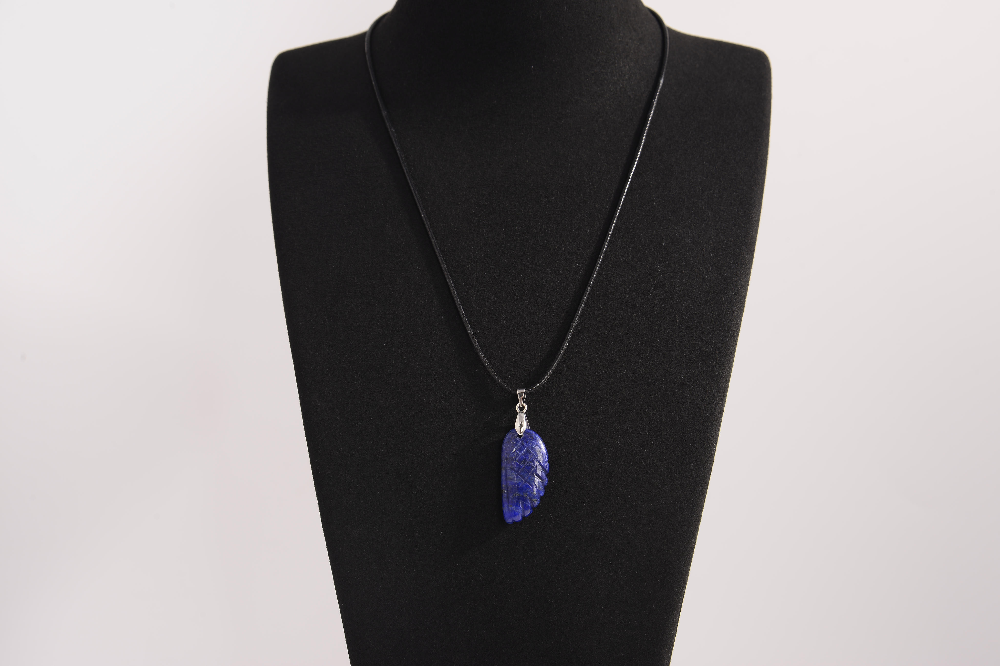 Raw Earth Crystals lapis lazuli pendant featuring an etched design, crafted from natural stone to promote truth, inner wisdom, and spiritual connection.