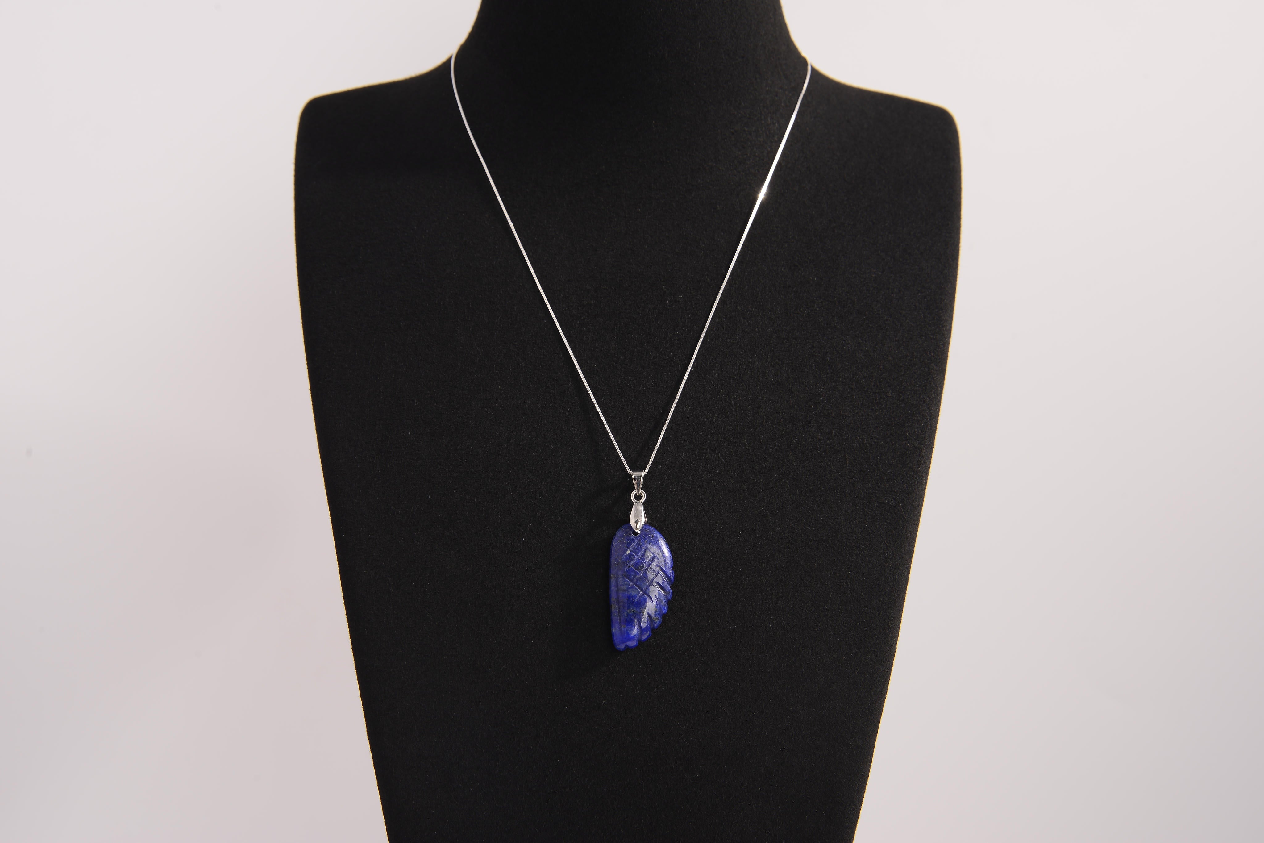 Raw Earth Crystals lapis lazuli pendant featuring an etched design, crafted from natural stone to promote truth, inner wisdom, and spiritual connection.