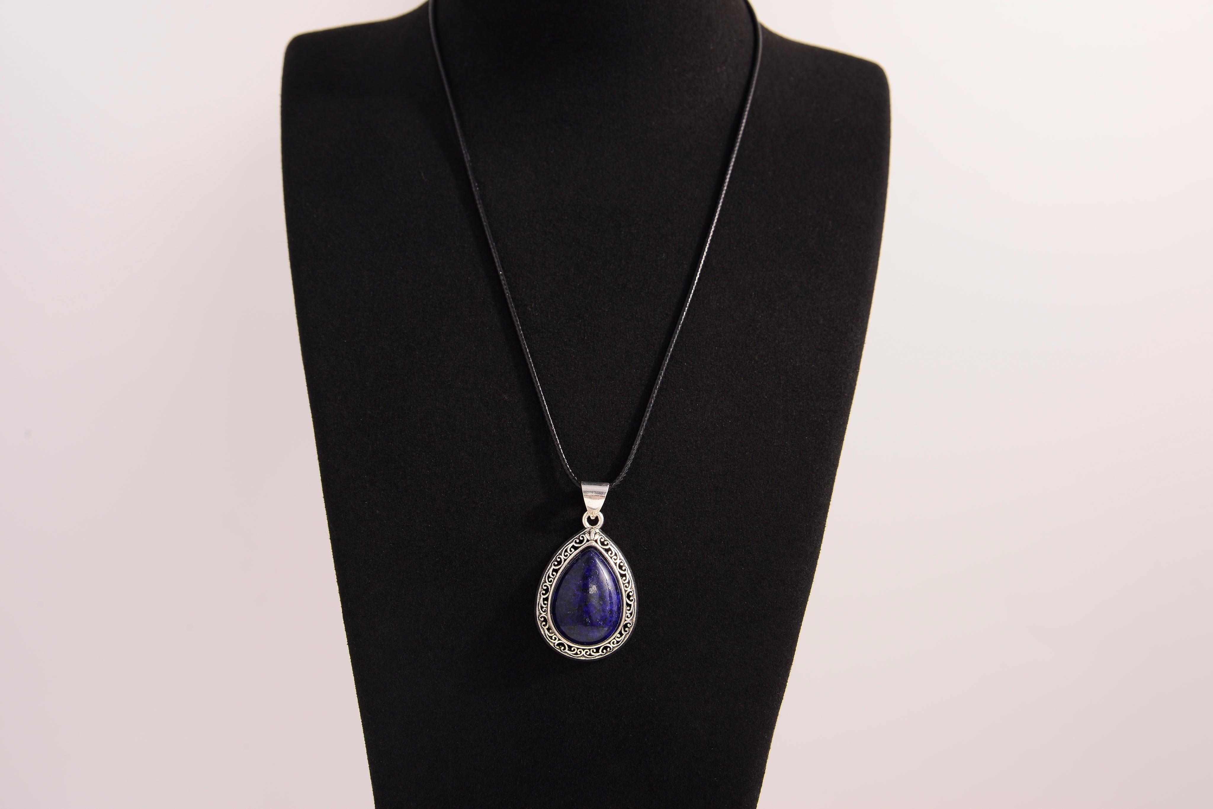 Raw Earth Crystals lapis lazuli pendant with a teardrop-shaped design, featuring natural lapis lazuli and an ornate silver-tone setting, promoting wisdom, truth, and spiritual insight.
