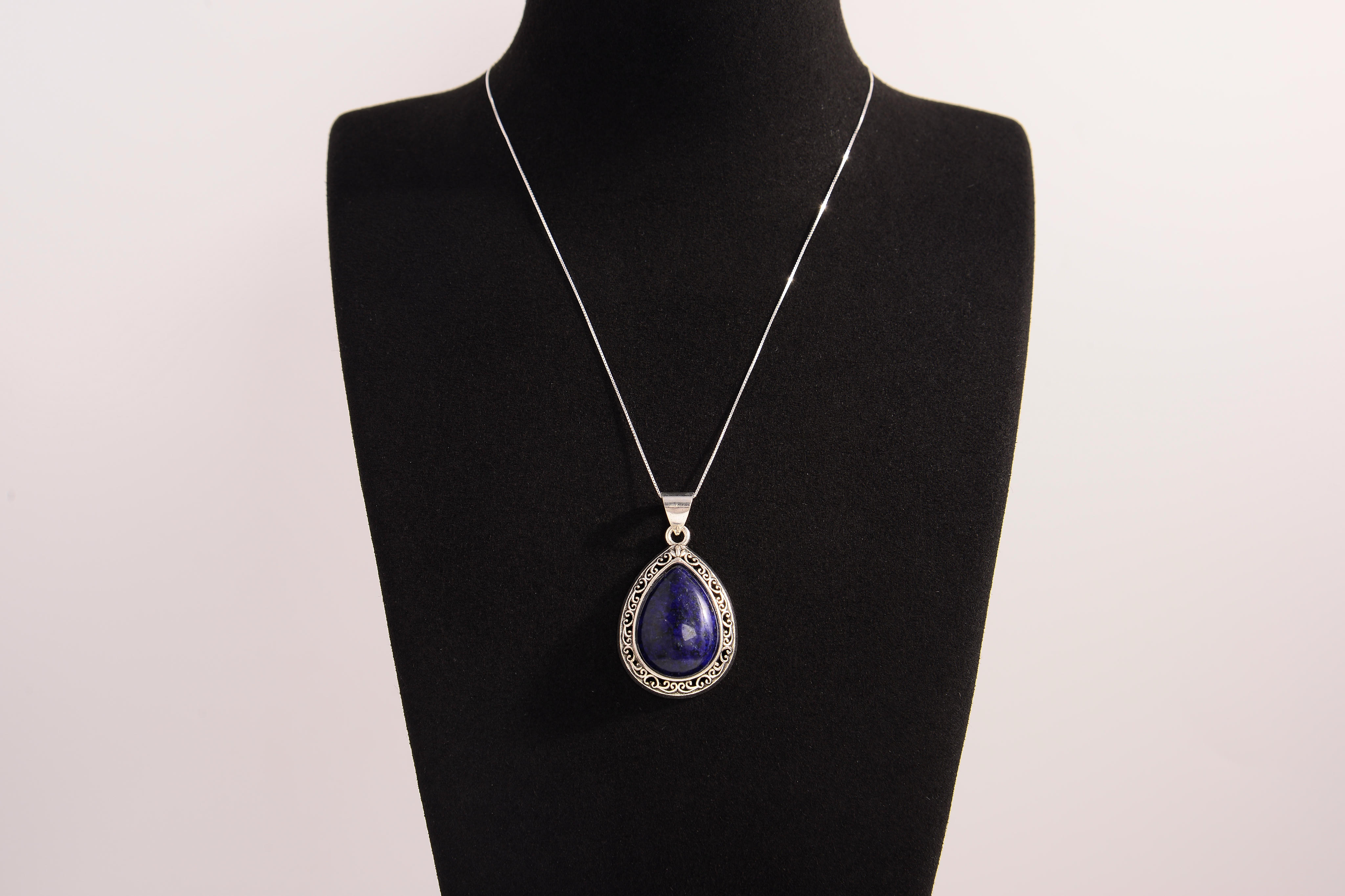 Raw Earth Crystals lapis lazuli pendant with a teardrop-shaped design, featuring natural lapis lazuli and an ornate silver-tone setting, promoting wisdom, truth, and spiritual insight.