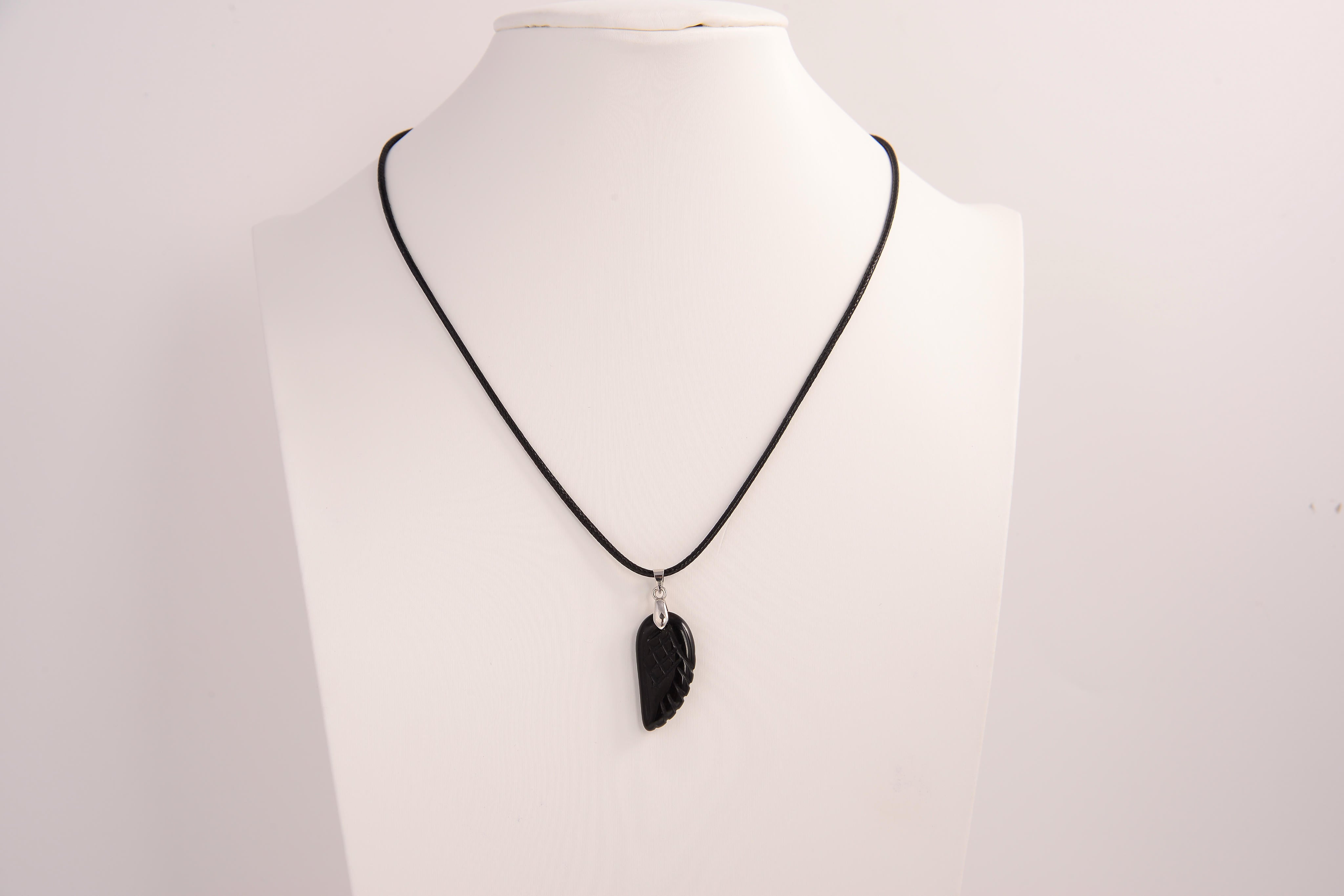Raw Earth Crystals obsidian angel wing pendant, featuring a polished black obsidian stone carved into an elegant wing shape and set on a silver-tone chain, promoting protection, grounding, and spiritual connection.