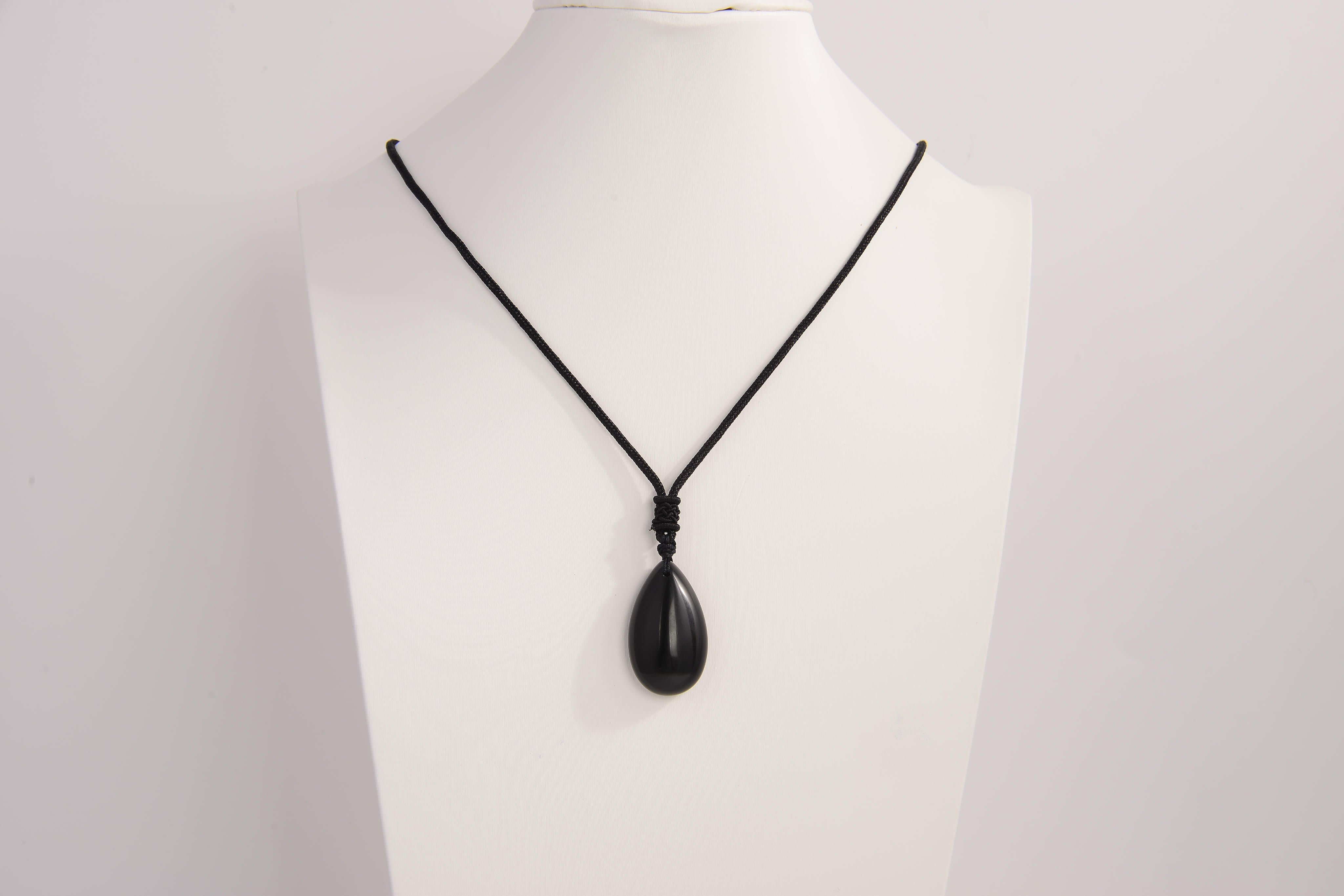 Raw Earth Crystals obsidian teardrop pendant on black cord, crafted from natural obsidian stone, promoting protection, grounding, and emotional clarity.