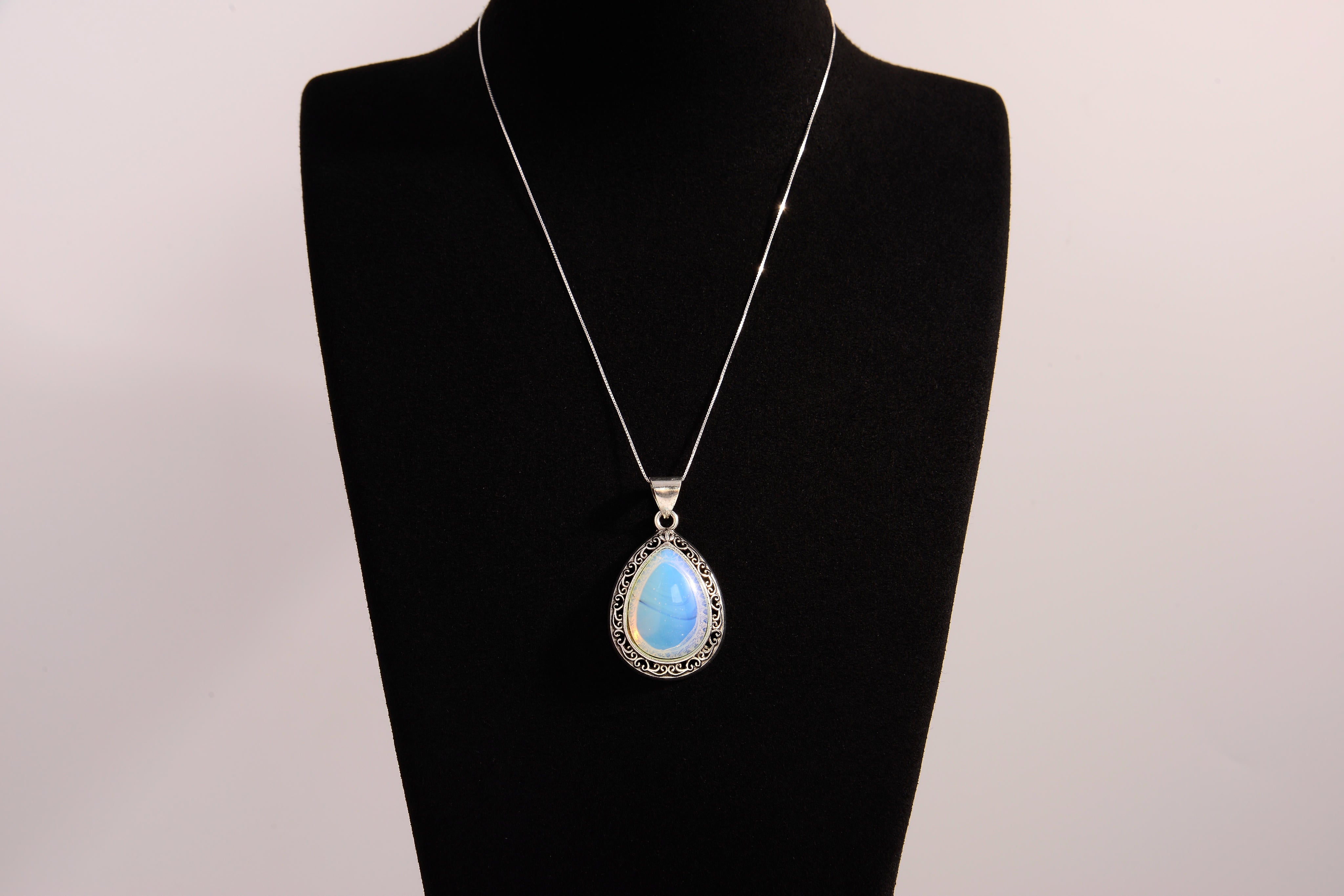 Raw Earth Crystals opalite pendant with a teardrop-shaped design, featuring natural opalite and an ornate silver-tone setting, enhancing emotional balance, intuition, and spiritual connection.