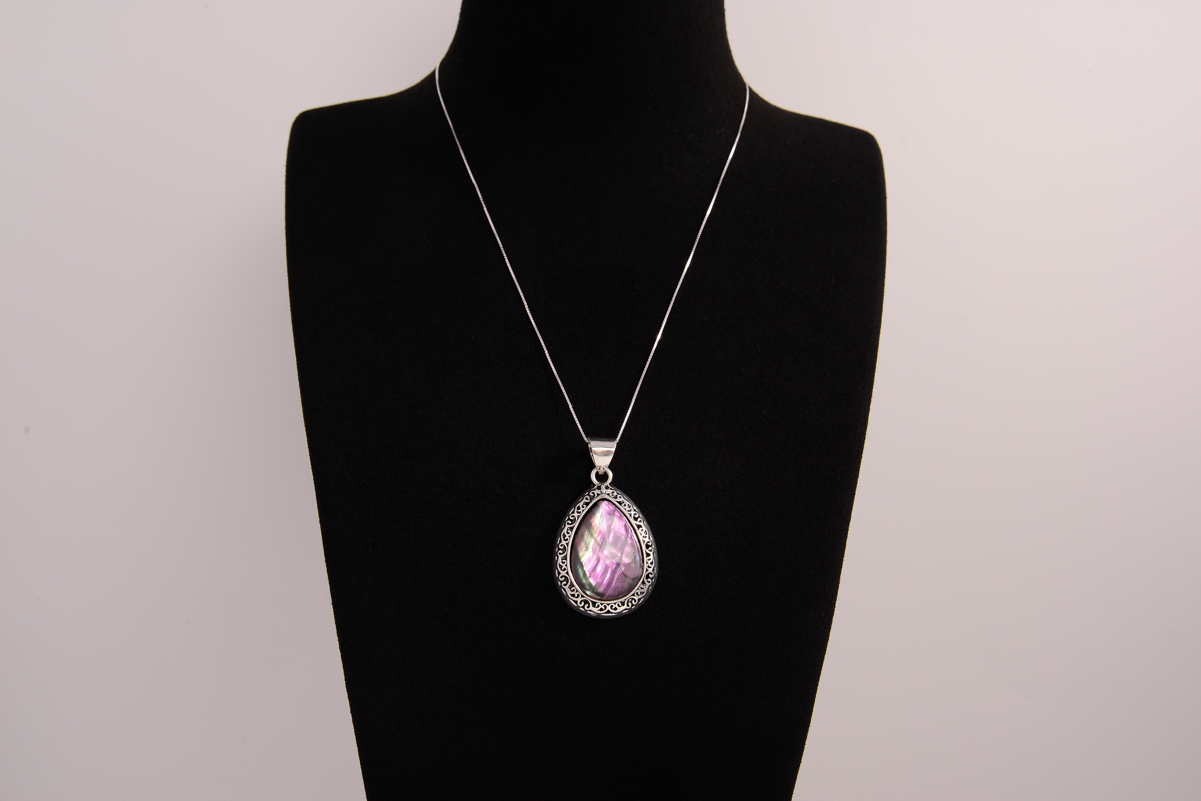 Raw Earth Crystals pink agate pendant with a teardrop-shaped design, featuring natural pink agate and an ornate silver-tone setting, promoting emotional balance, self-love, and gentle energy.