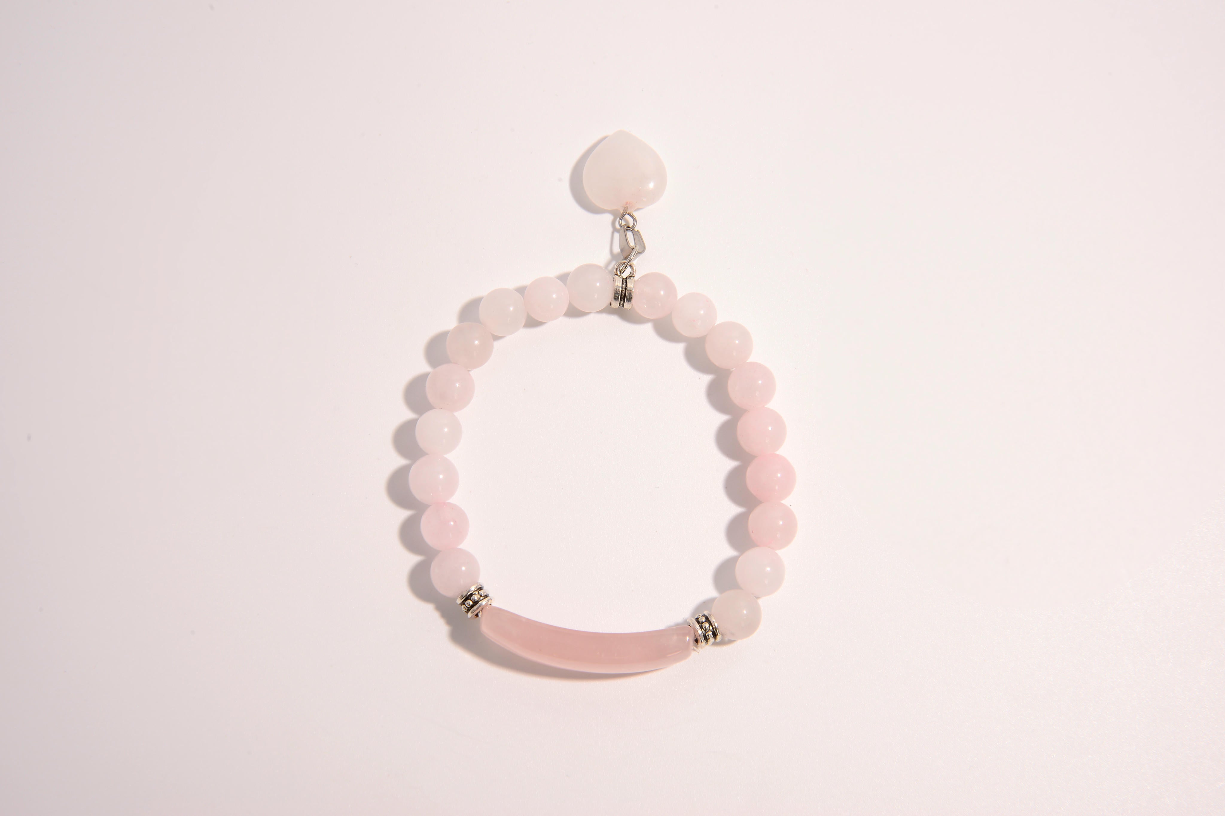 Raw Earth Crystals pink rose quartz bracelet with raw stone accent, crafted from natural crystal, promotes love, compassion, and emotional healing.