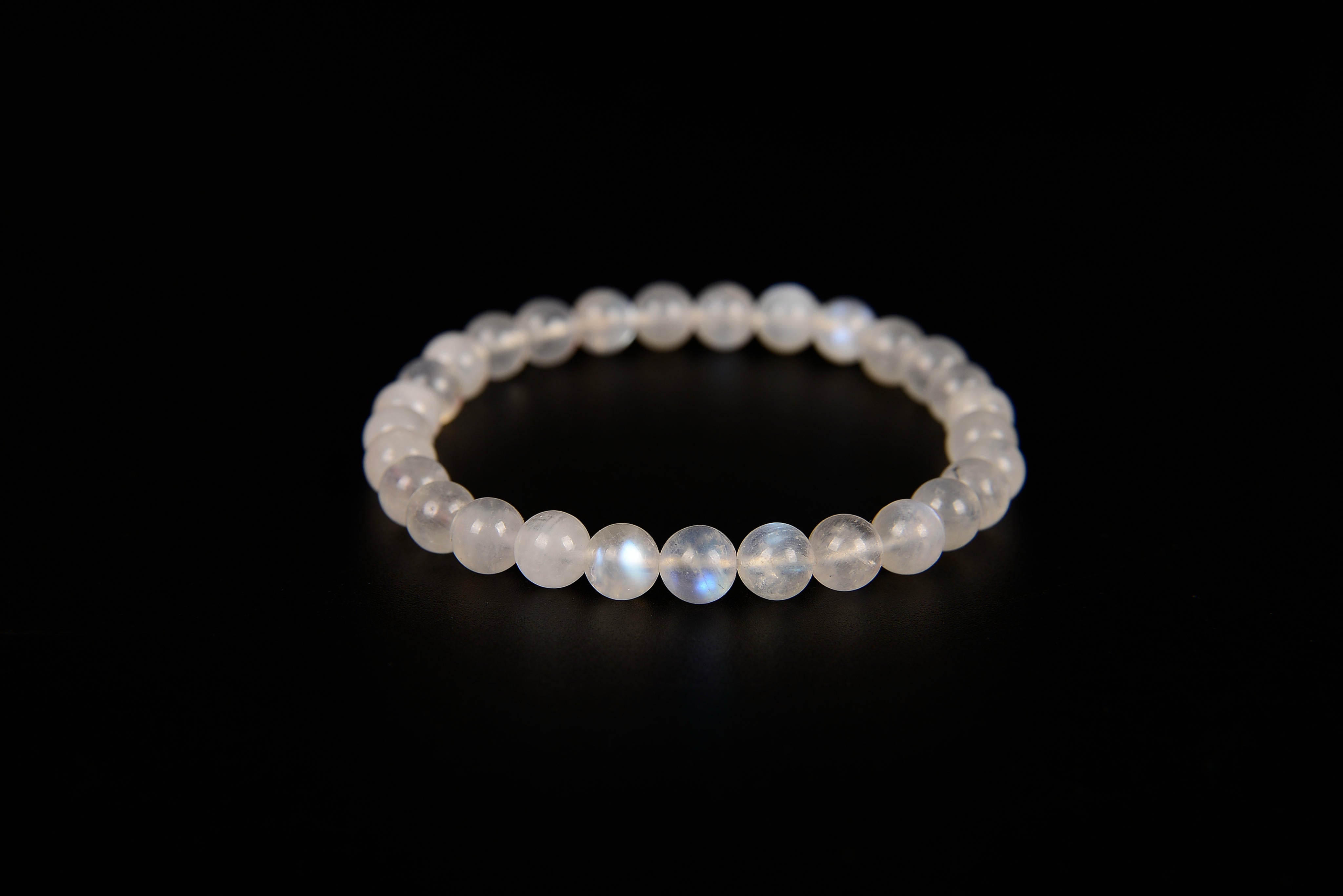 Rainbow moonstone beaded bracelet from Raw Earth Crystals, featuring natural gemstones with iridescent glow for intuition, emotional healing, and spiritual clarity.
