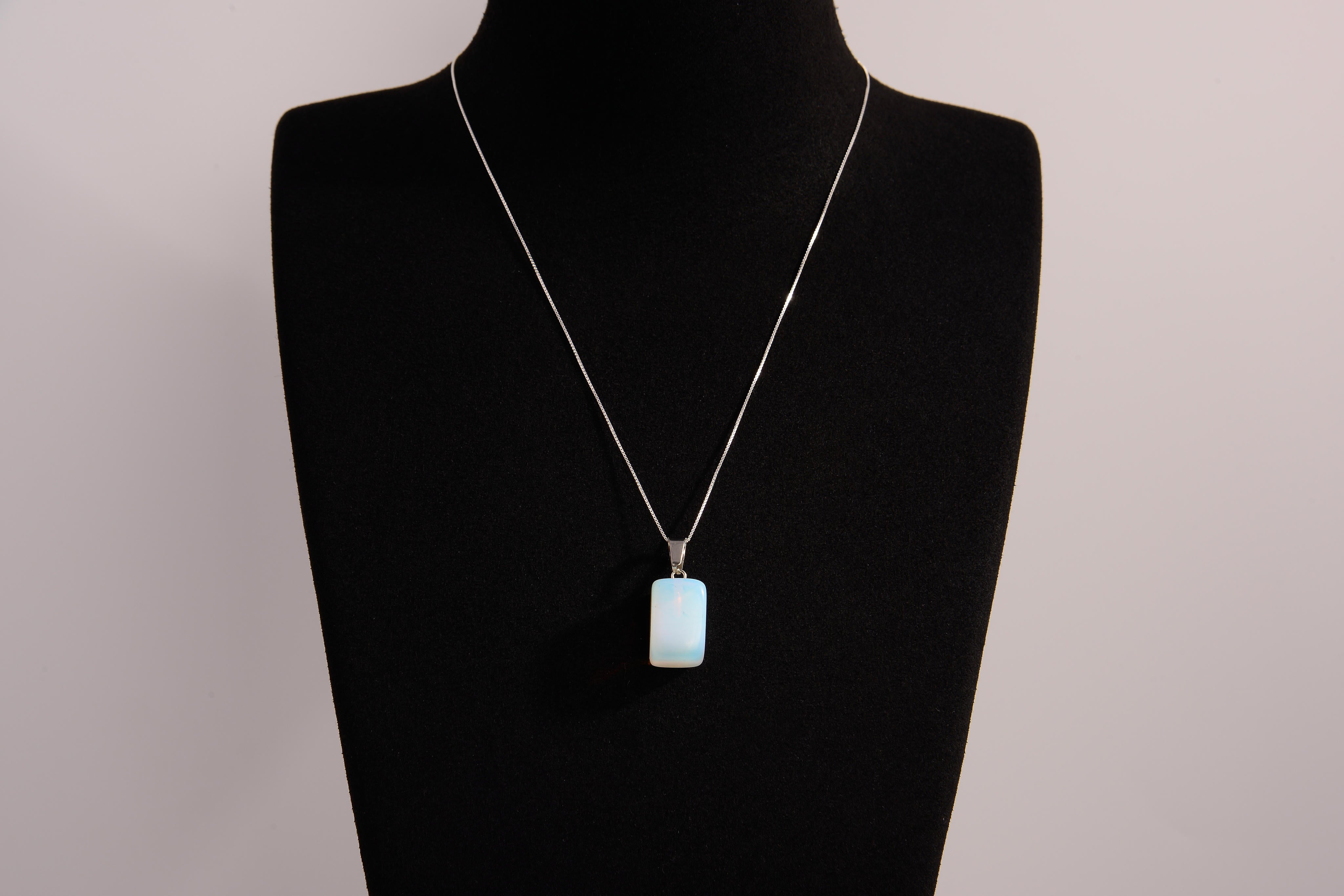 Raw Earth Crystals rectangle pendant featuring a polished opalite cabochon set in a sleek silver-toned bail, symbolizing serenity, emotional balance, and spiritual insight.