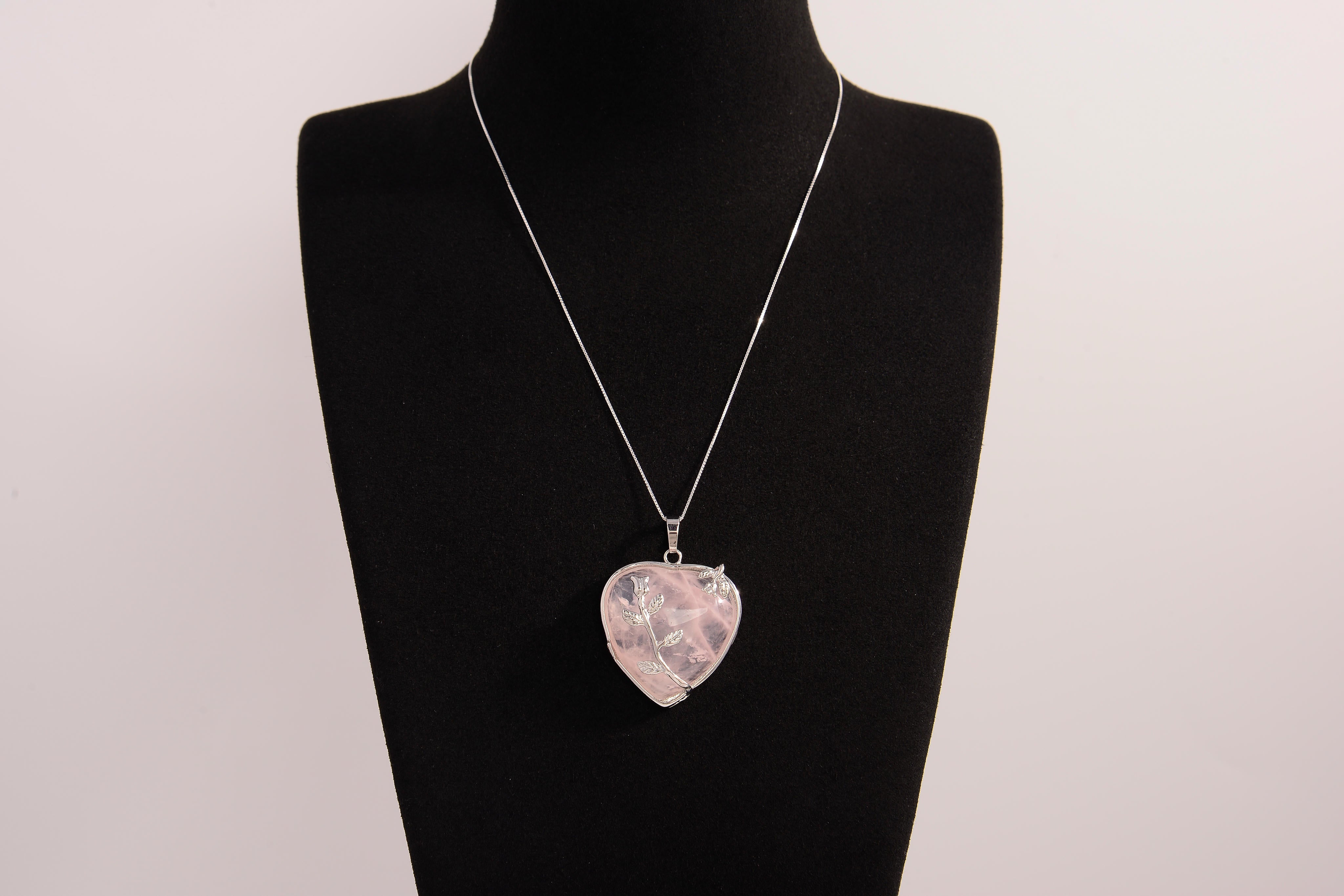 Raw Earth Crystals rose quartz heart pendant with an elegant rose design, featuring a soft pink rose quartz stone and a silver-tone vine with leaves, promoting love, compassion, and emotional healing.