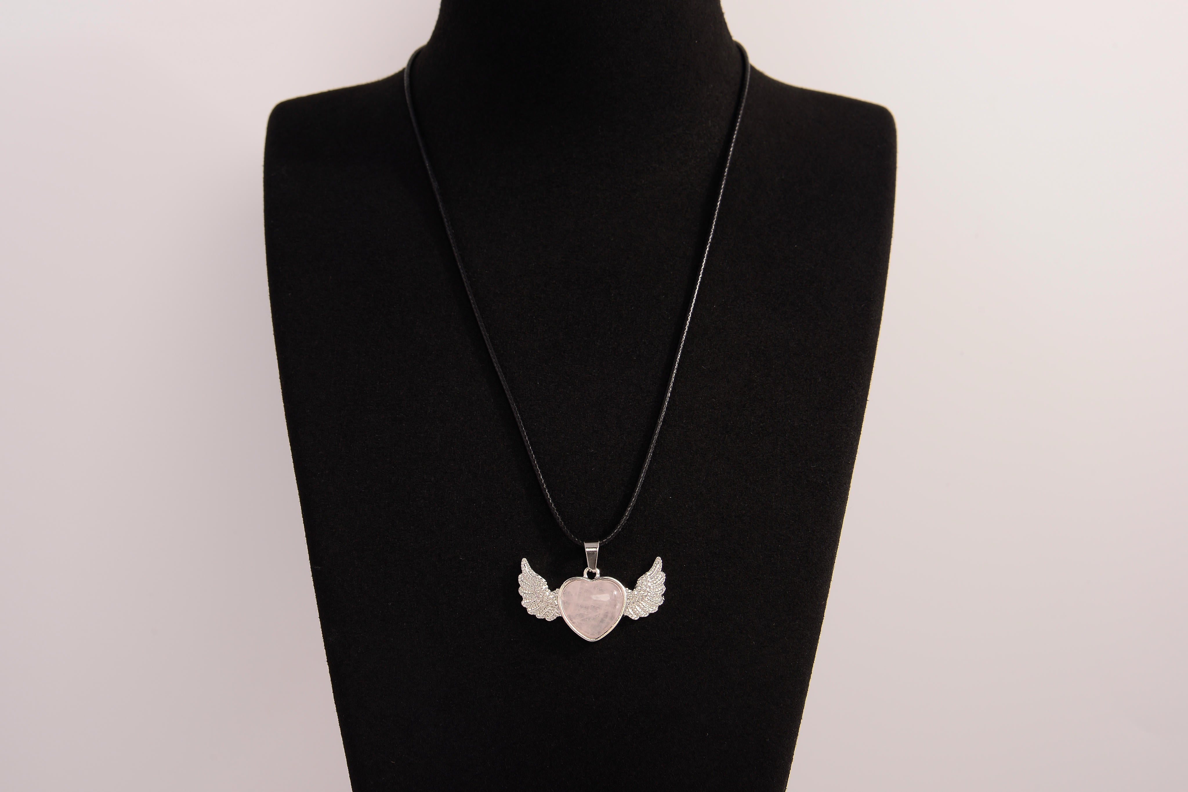 Raw Earth Crystals rose quartz heart with wings necklace, featuring a soft pink heart-shaped stone adorned with delicate angelic wings, designed to enhance love, compassion, and emotional healing.
