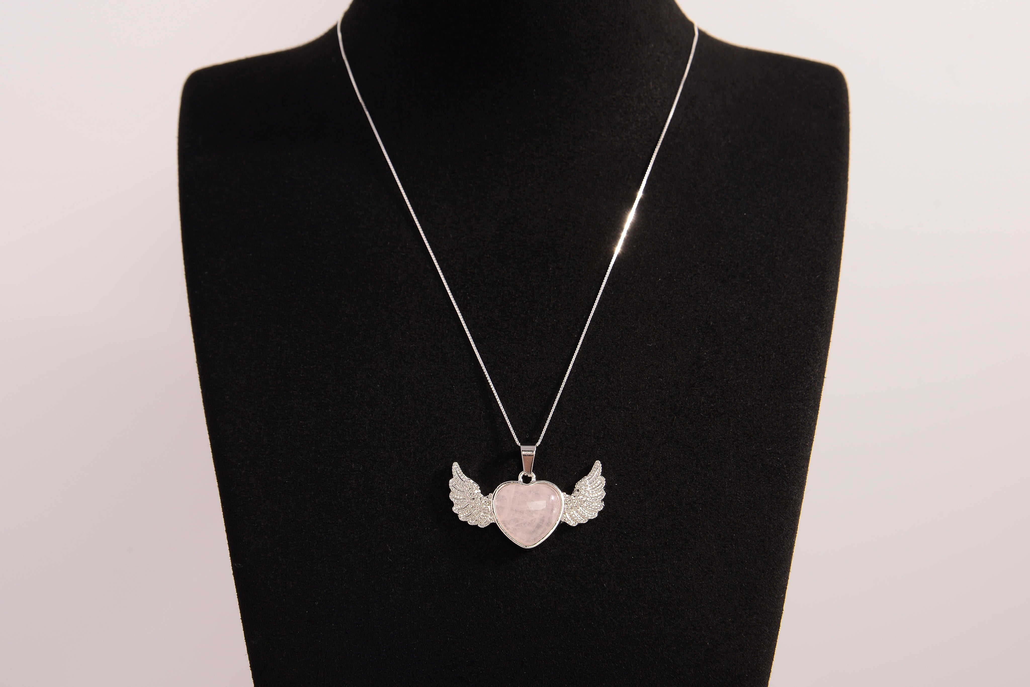 Raw Earth Crystals rose quartz heart with wings necklace, featuring a soft pink heart-shaped stone adorned with delicate angelic wings, designed to enhance love, compassion, and emotional healing.
