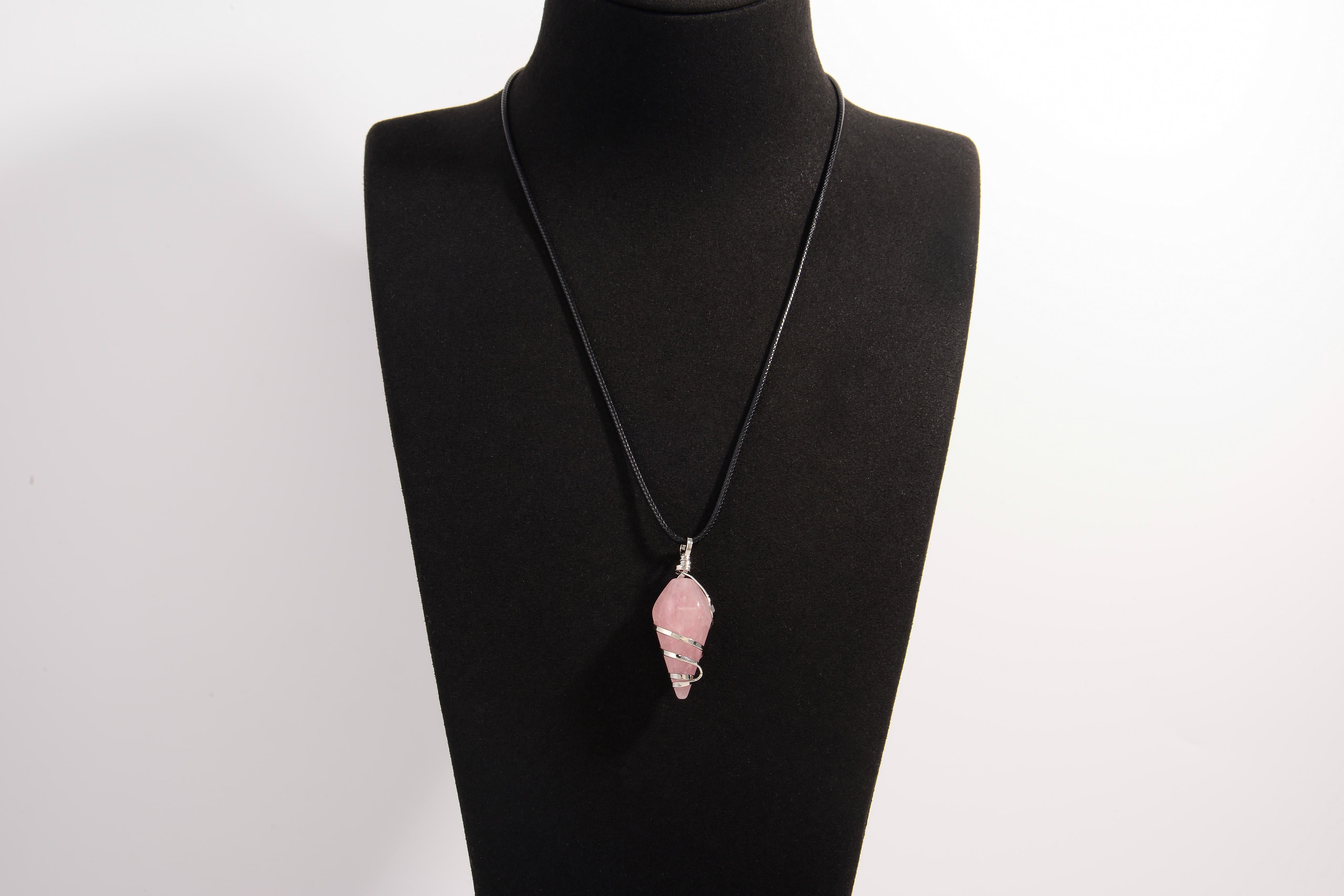 Raw Earth Crystals rose quartz pendant with a spiral wire wrap design, crafted from natural stone to foster love, compassion, and emotional healing.