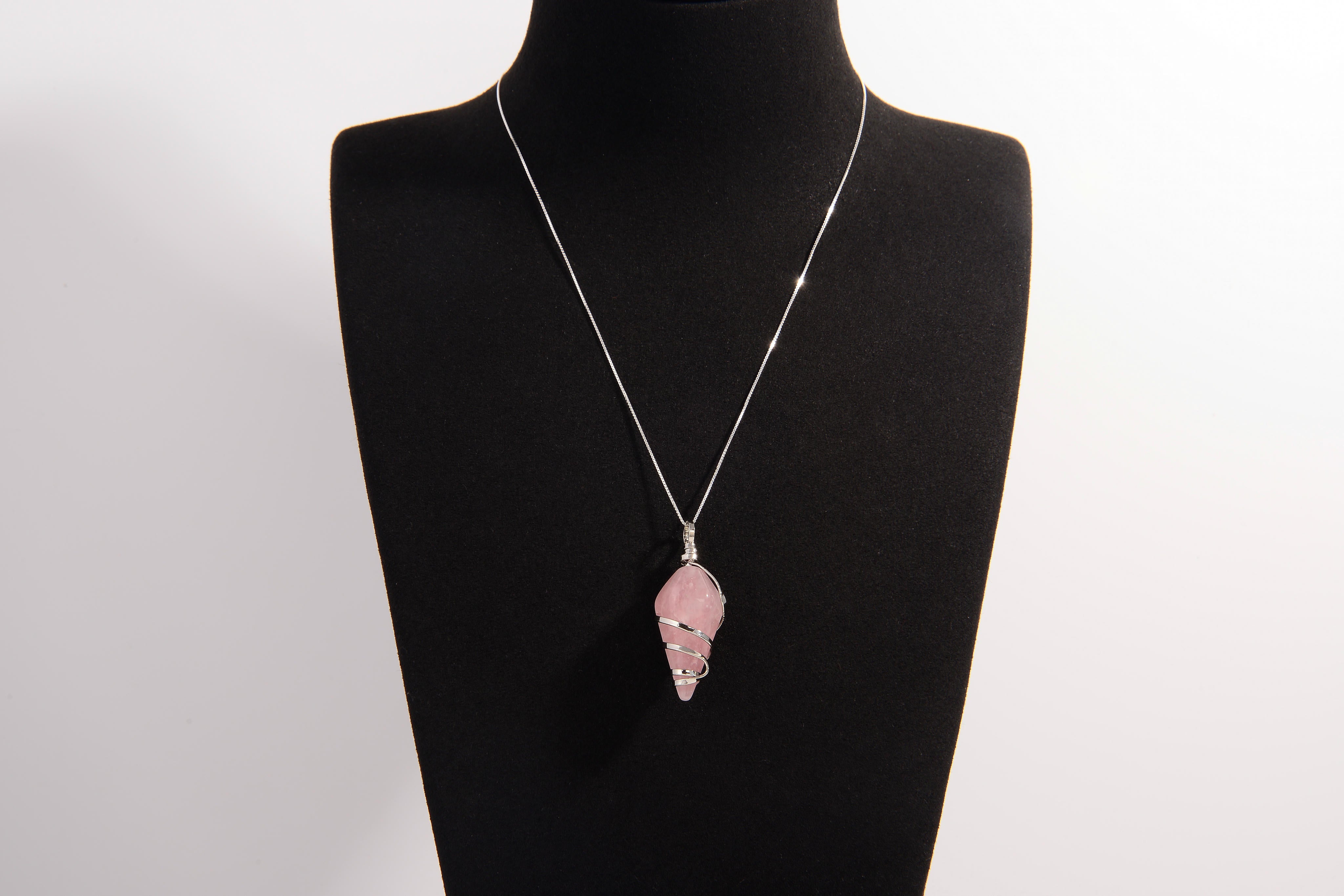 Raw Earth Crystals rose quartz pendant with a spiral wire wrap design, crafted from natural stone to foster love, compassion, and emotional healing.