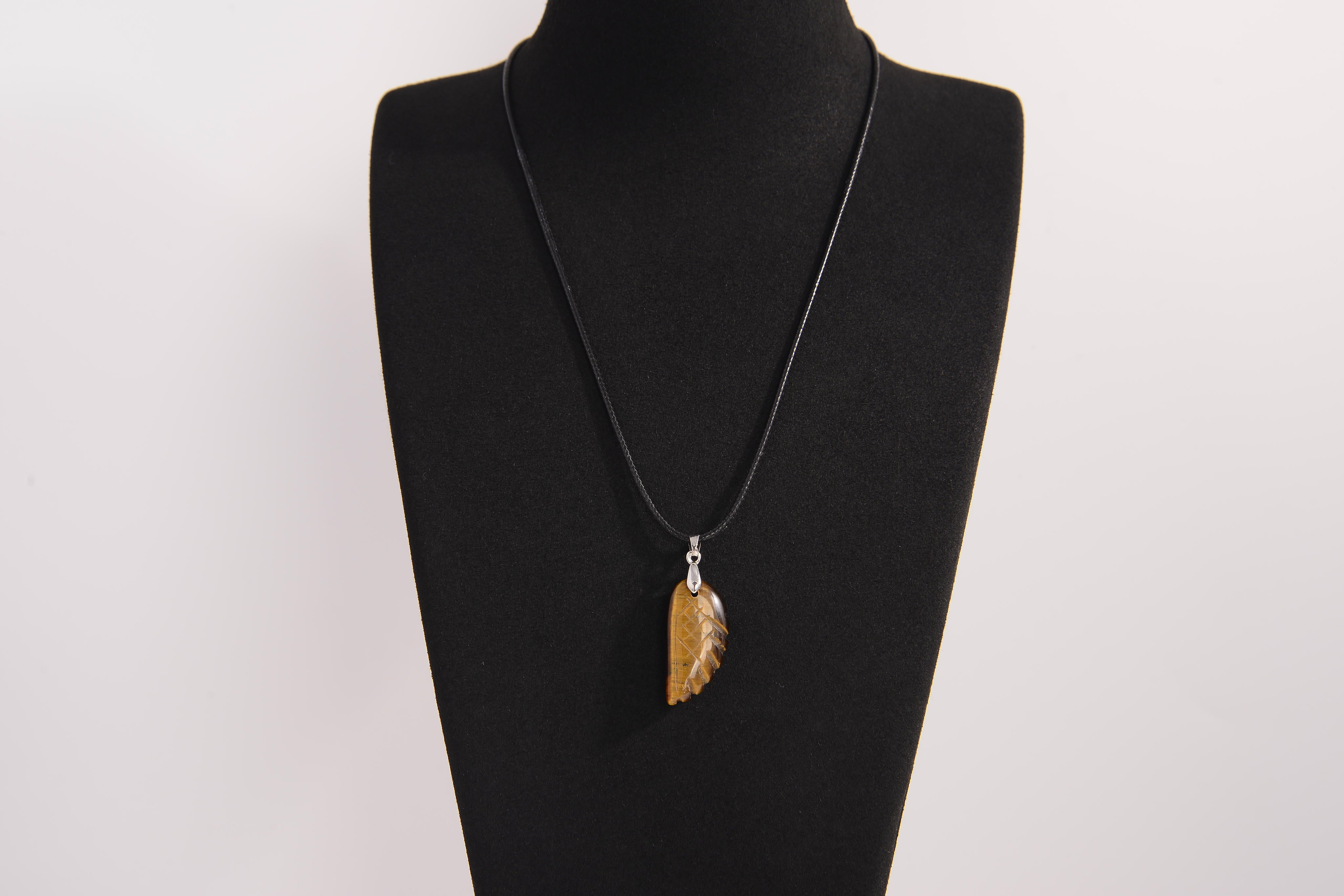 Raw Earth Crystals tiger eye pendant featuring an etched design, crafted from natural stone to promote balance, protection, and clarity.