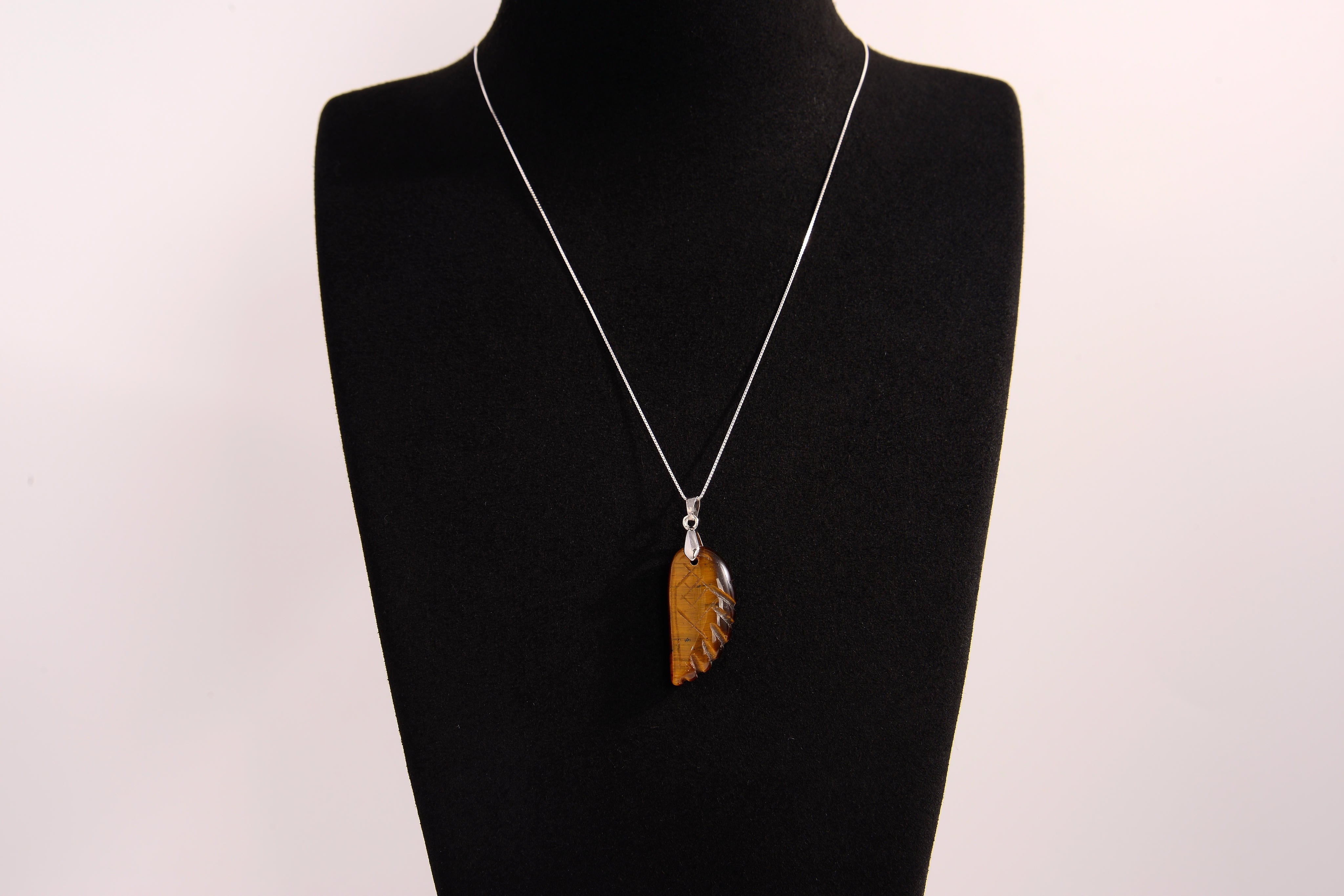 Raw Earth Crystals tiger eye pendant featuring an etched design, crafted from natural stone to promote balance, protection, and clarity.