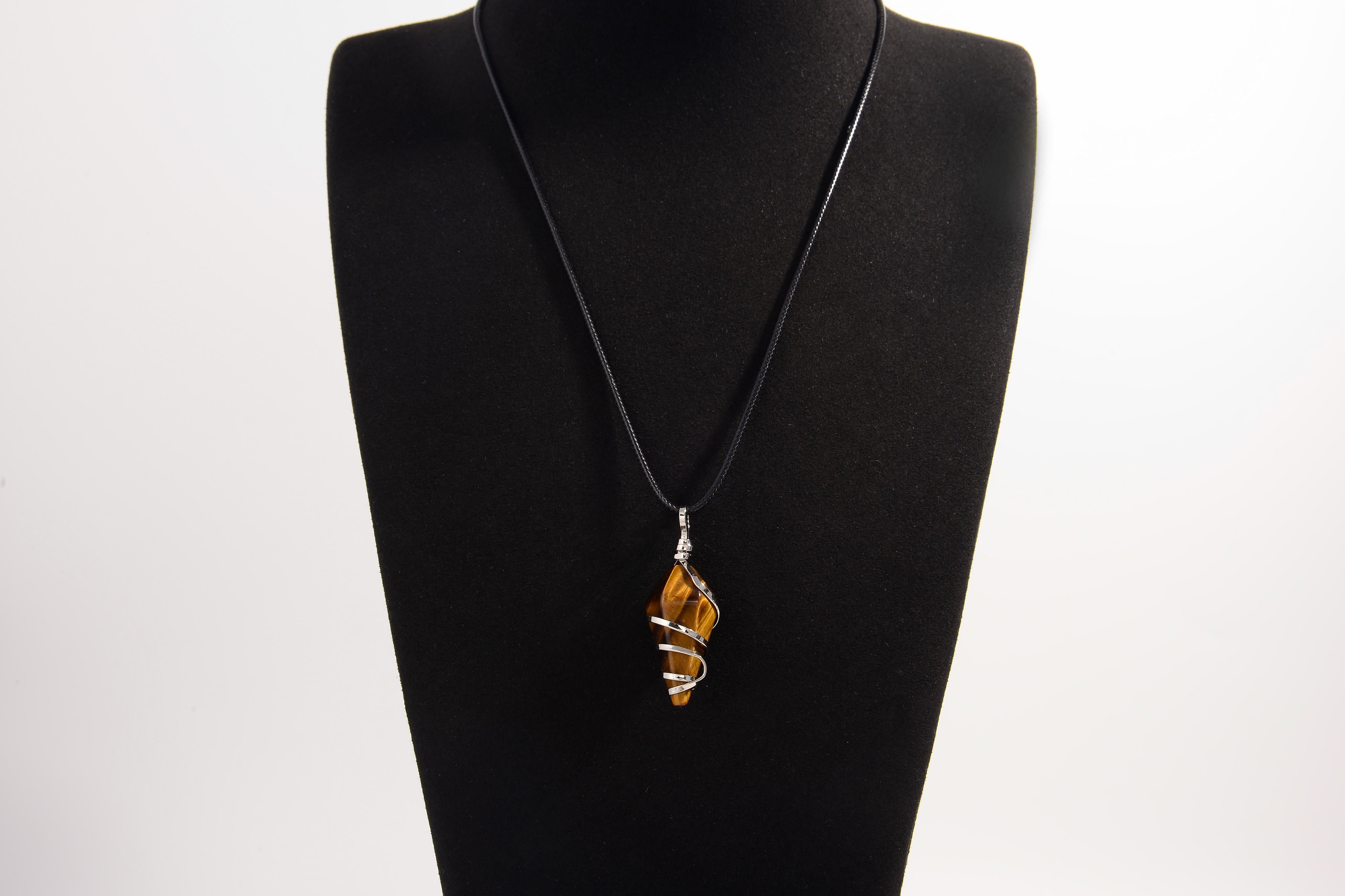 Raw Earth Crystals tiger eye pendant with a spiral wire wrap design, crafted from natural stone to promote confidence, protection, and grounding energy.
