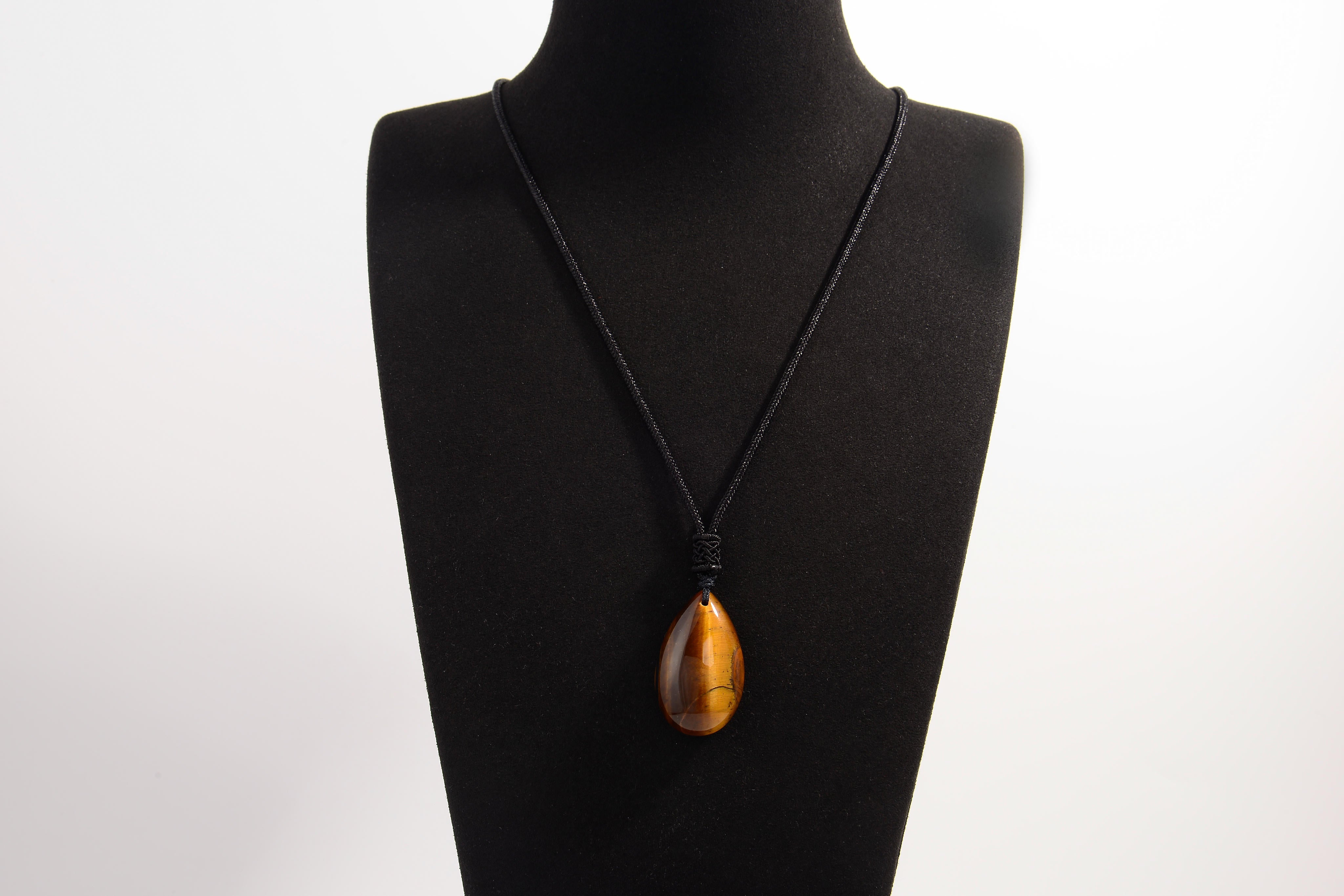 Raw Earth Crystals tiger eye teardrop pendant on black cord, crafted from natural tiger eye stone, promoting confidence, focus, and personal power.