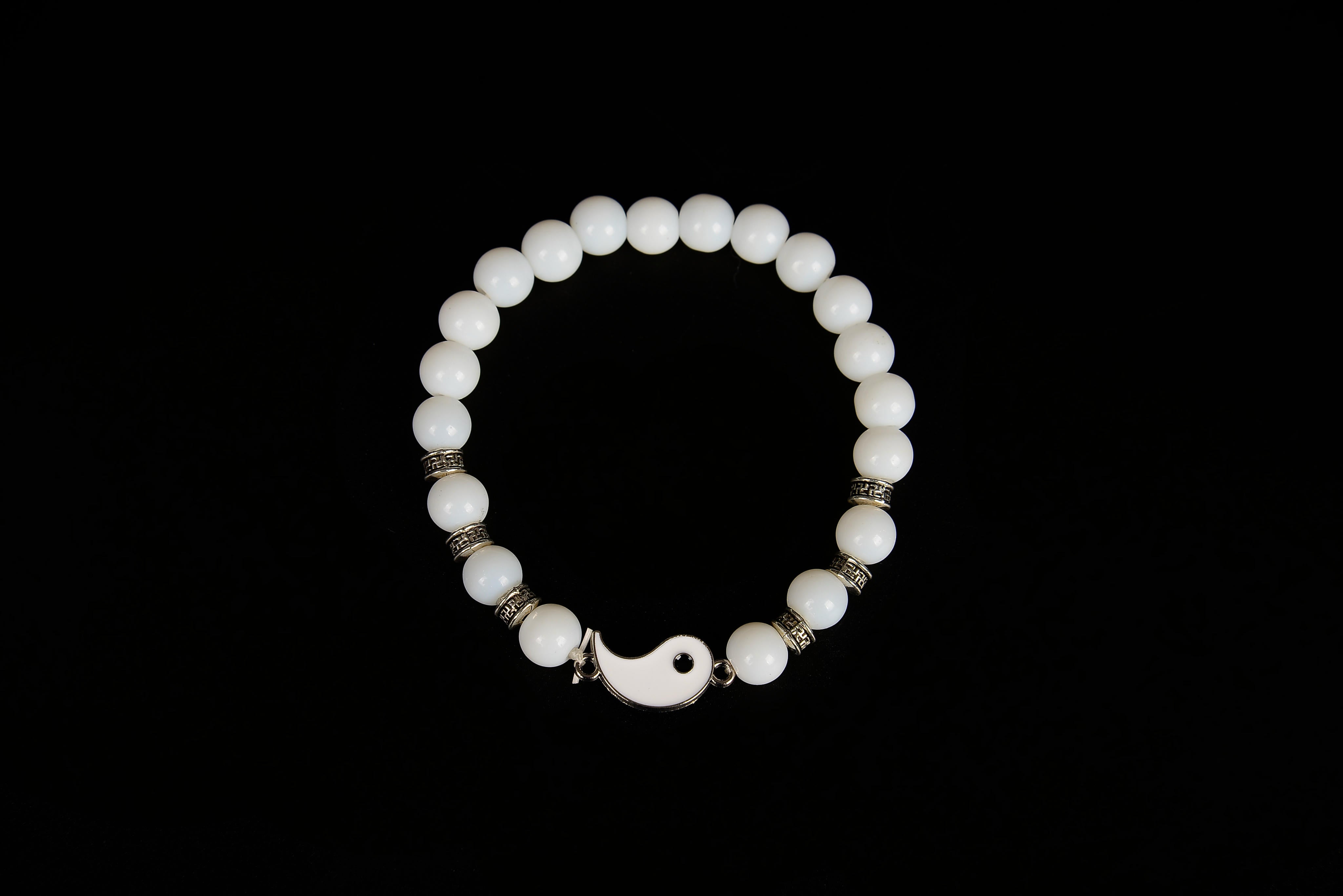 Raw Earth Crystals white jade bracelet with yin yang design, crafted from natural crystal, enhances clarity, peace, and emotional balance.
