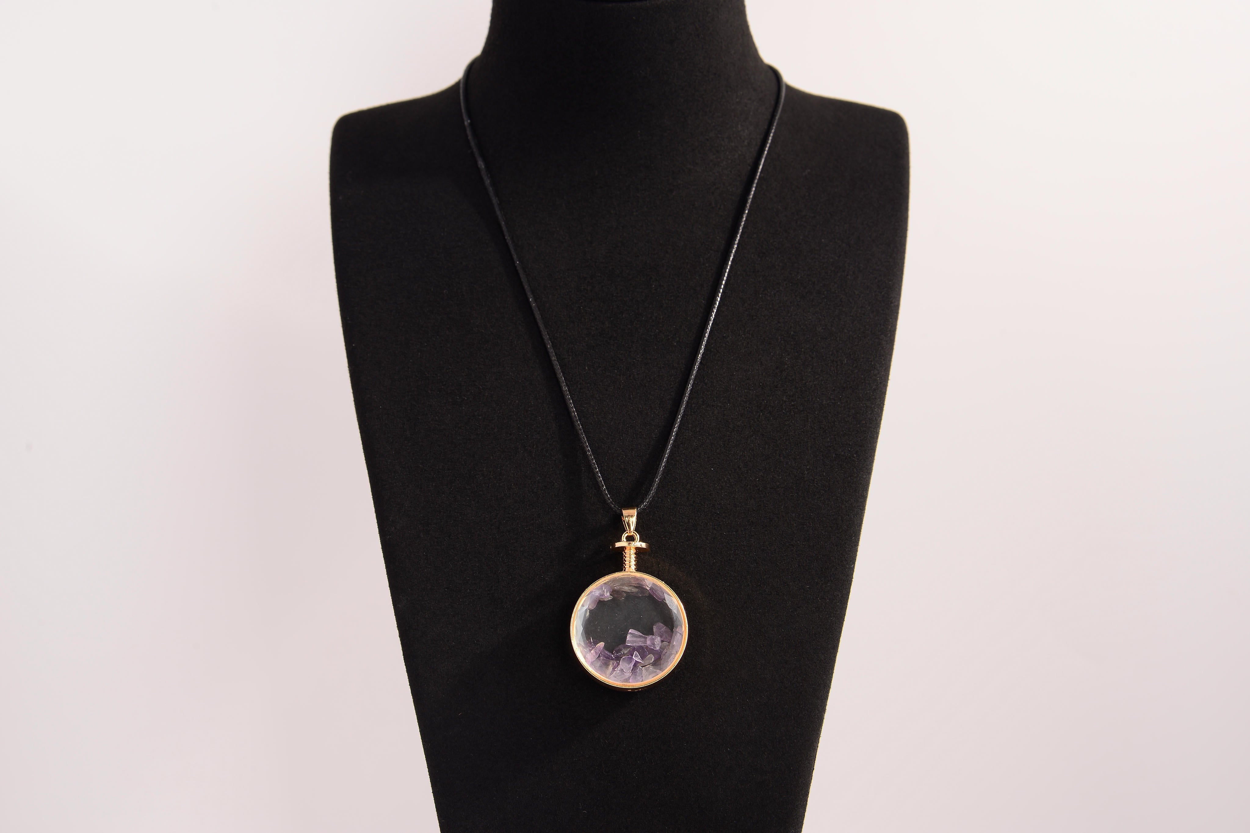 Raw Earth Crystals amethyst pendant with a crystal-encased design, featuring natural amethyst and gold-tone setting, enhancing intuition, calmness, and spiritual awareness.