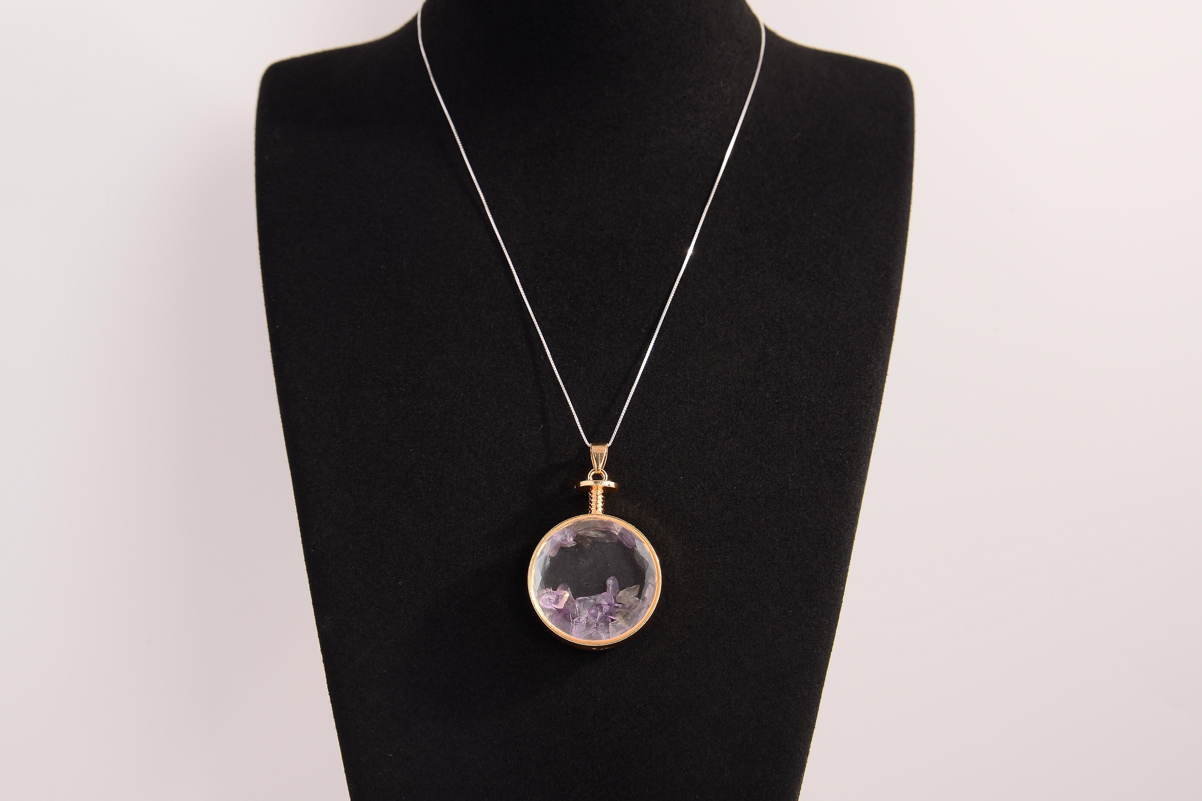 Raw Earth Crystals amethyst pendant with a crystal-encased design, featuring natural amethyst and gold-tone setting, enhancing intuition, calmness, and spiritual awareness.