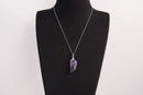 Raw Earth Crystals amethyst pendant featuring an etched design, crafted from natural stone to enhance spiritual awareness, calm the mind, and support emotional balance.