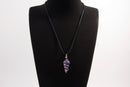 Raw Earth Crystals amethyst pendant with a spiral wire wrap design, crafted from natural stone to support spiritual growth, intuition, and inner peace.