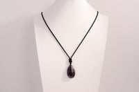 Raw Earth Crystals amethyst teardrop pendant on black cord, made from natural amethyst stone, supporting spiritual growth, calmness, and intuitive clarity.