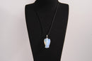 Raw Earth Crystals angel pendant crafted from carved opalite, featuring a soft, milky blue iridescence to promote calmness, emotional healing, and spiritual clarity.