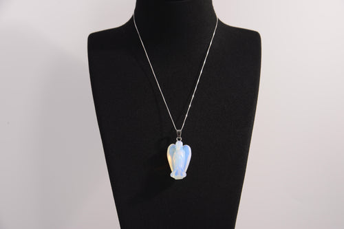 Raw Earth Crystals angel pendant crafted from carved opalite, featuring a soft, milky blue iridescence to promote calmness, emotional healing, and spiritual clarity.